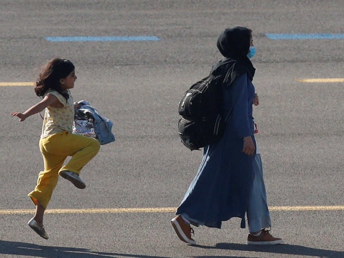 <p>The picture of the girl was taken by Reuters photographer Johanna Geron at a military airport near Brussels earlier this week </p>