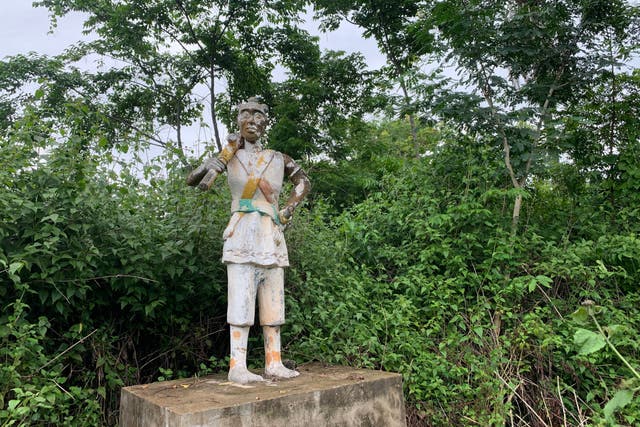 <p>The stone statue of an Amazon in a village near Abomey, Benin</p>