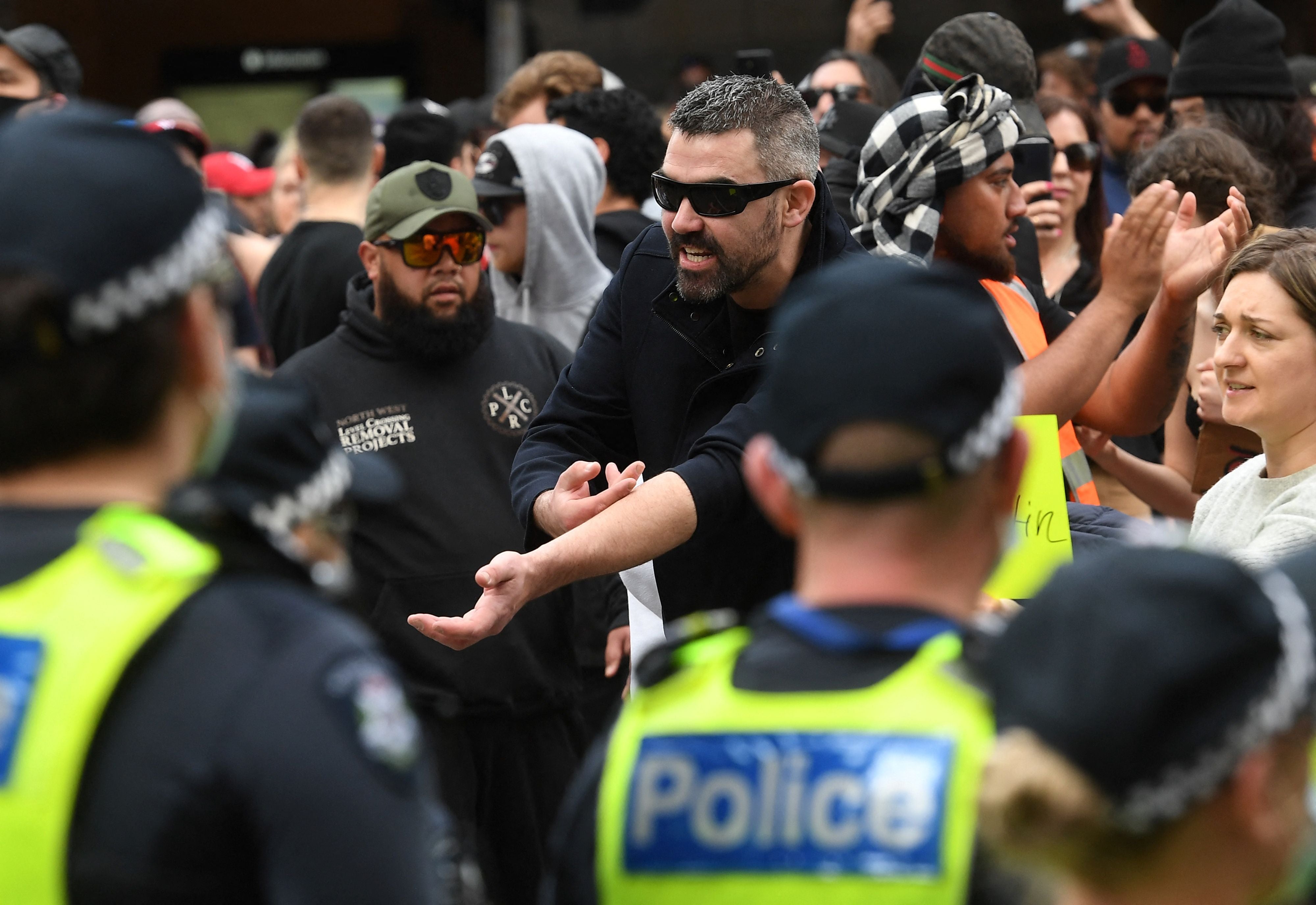 Protesters march through the streets during an anti-lockdown rally in Melbourne as the city experiences its sixth lockdown