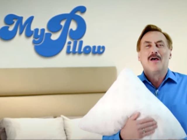 <p>Mike Lindell, the CEO of MyPillow, hugs one of his pillows in a television advertisement.</p>