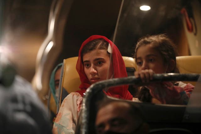 <p>Afghan evacuees from Afghanistan sit in a bus after the arrival of the second flight with 95 passengers at the International Airport in Tirana, Albania</p>