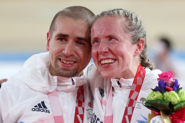 <p>Gold medalists Neil and Lora Fachie celebrate at the Izu Velodrome</p>