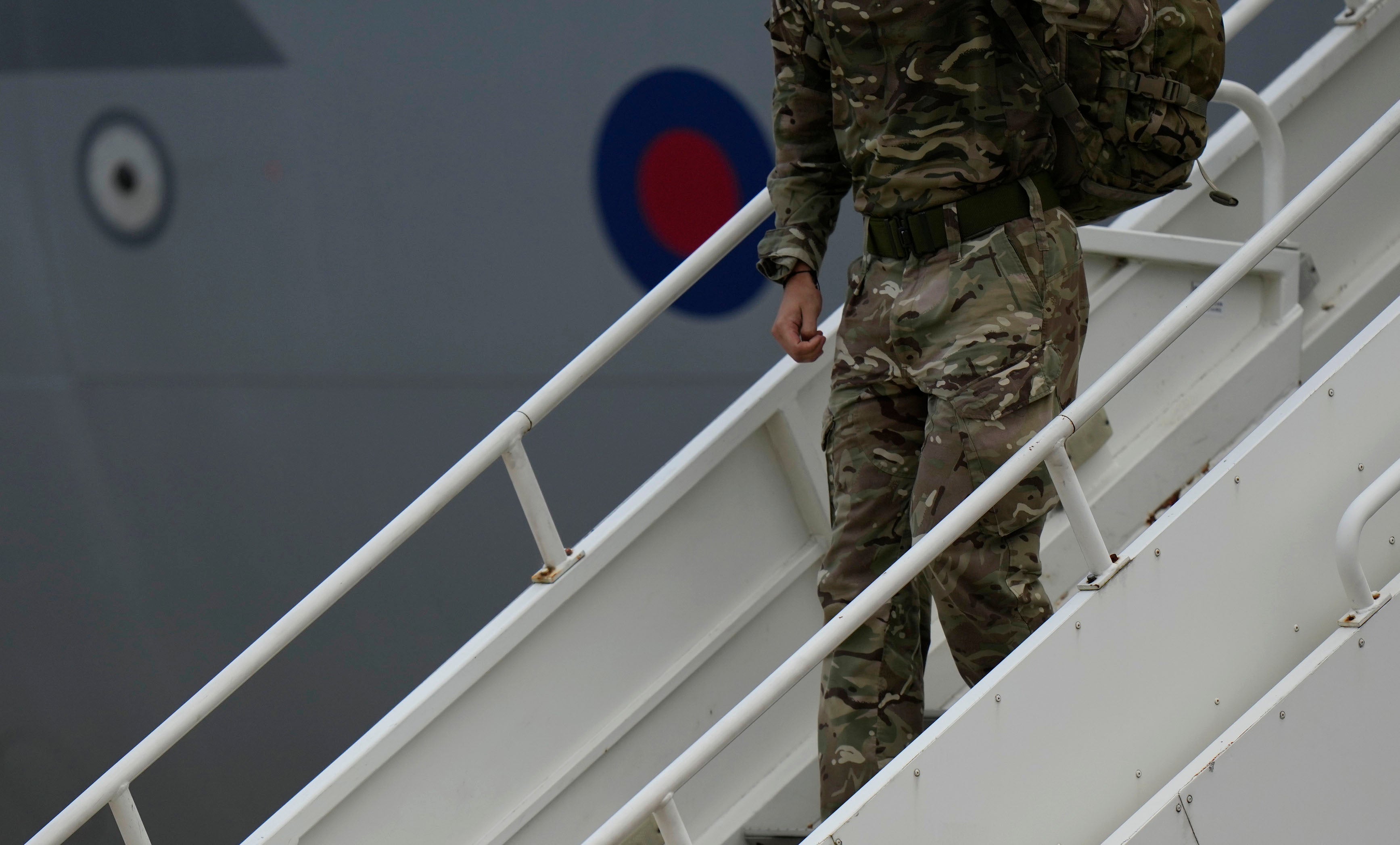 A member of the British armed forces disembarks an RAF Voyager aircraft at Brize Norton as they return from helping in operations to evacuate people from Kabul airport