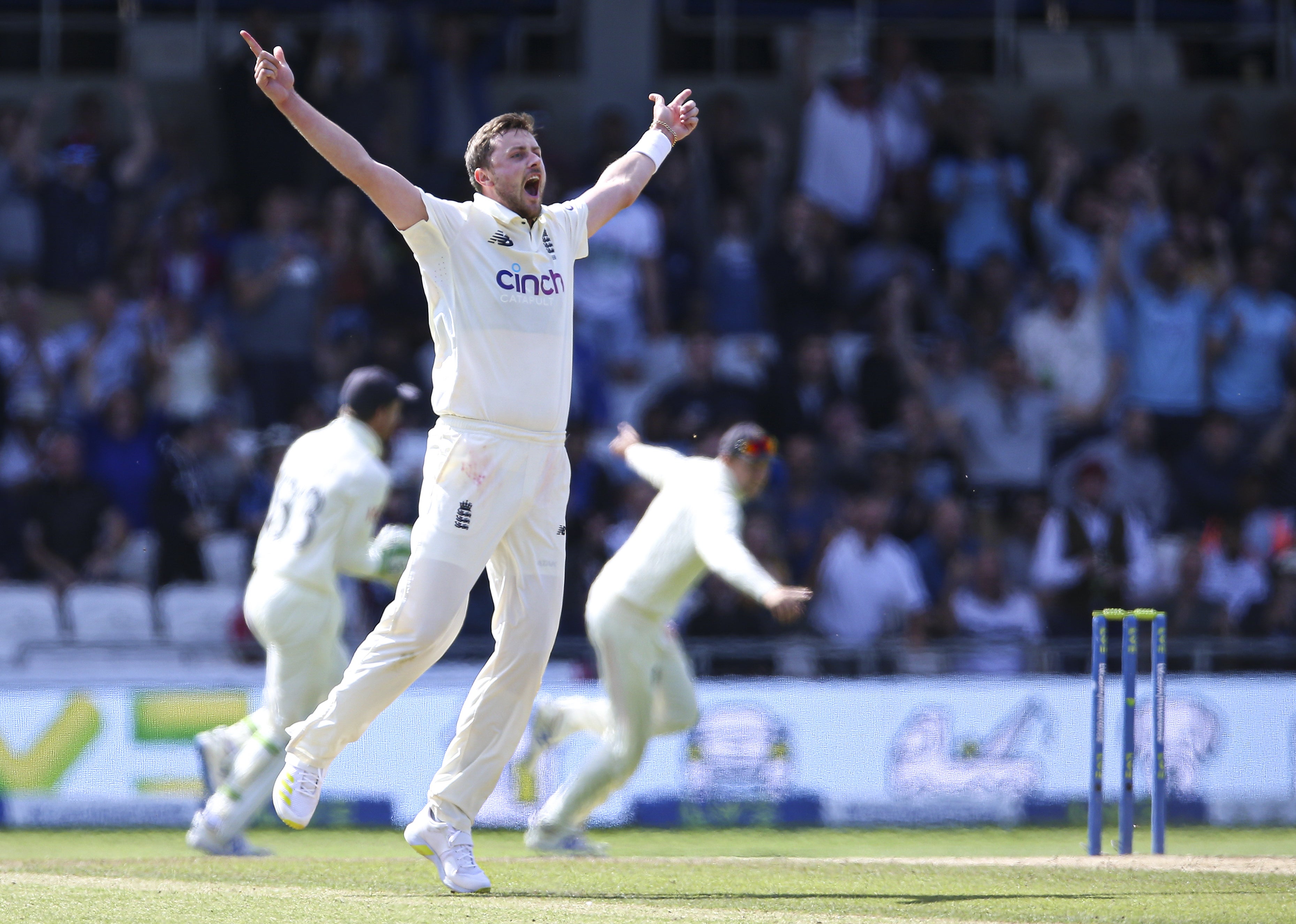 England’s Ollie Robinson celebrates after taking the wicket of India’s Virat Kohli .