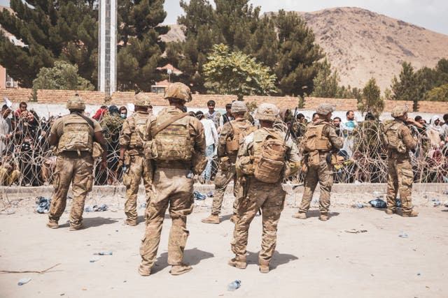 <p>U.S. Soldiers and Marines assist with security at an Evacuation Control Checkpoint during an evacuation at Hamid Karzai International Airport, August  19, 2021 in Kabul, Afghanistan. </p>