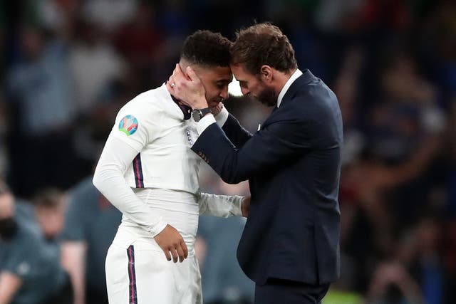 England manager Gareth Southgate consoles Jadon Sancho following defeat in the penalty shoot-out against Italy in the Euro 2020 Final at Wembley (Nick Pots/PA Images).