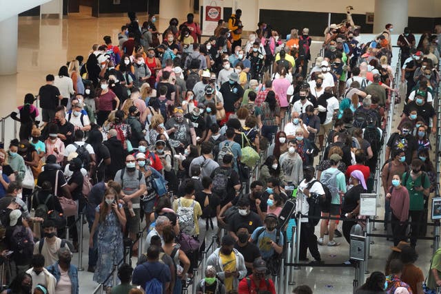 <p>People stand in line to get through the security checkpoint at Louis Armstrong New Orleans International Airport</p>