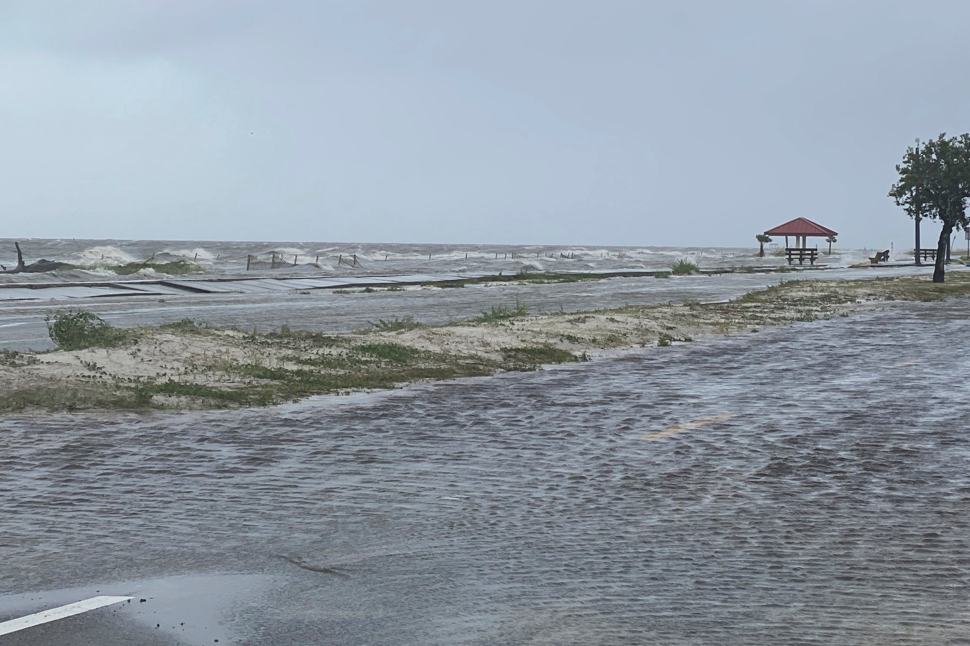 Highway 90 westbound in Pass Christian, Miss. overflows with flooding waters early as a result of the arrival of Hurricane Ida on Sunday, Aug. 29, 2021. (Hunter Dawkins/The Gazebo Gazette via AP)