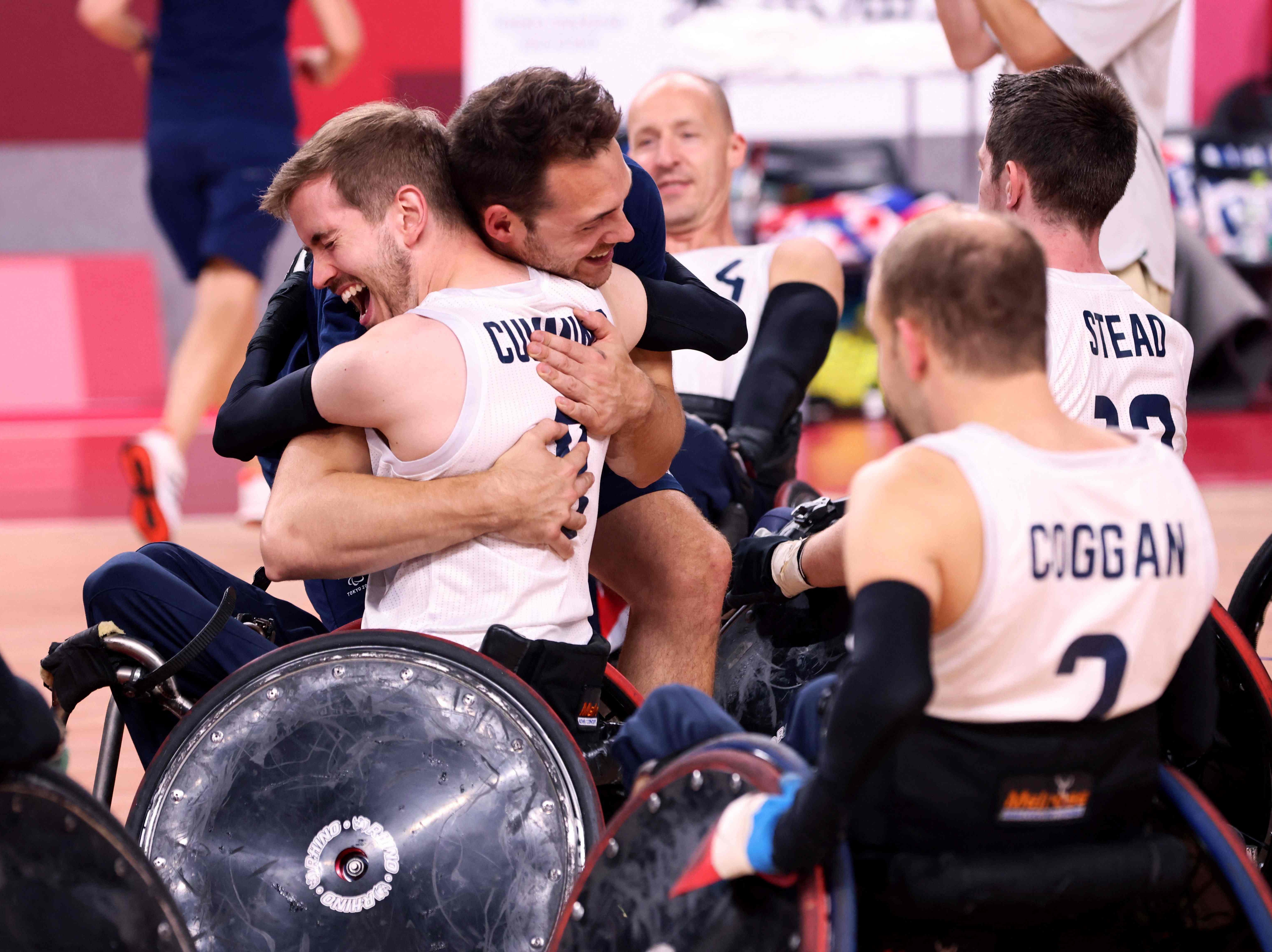 Britain’s players celebrate victory in the wheelchair rugby final