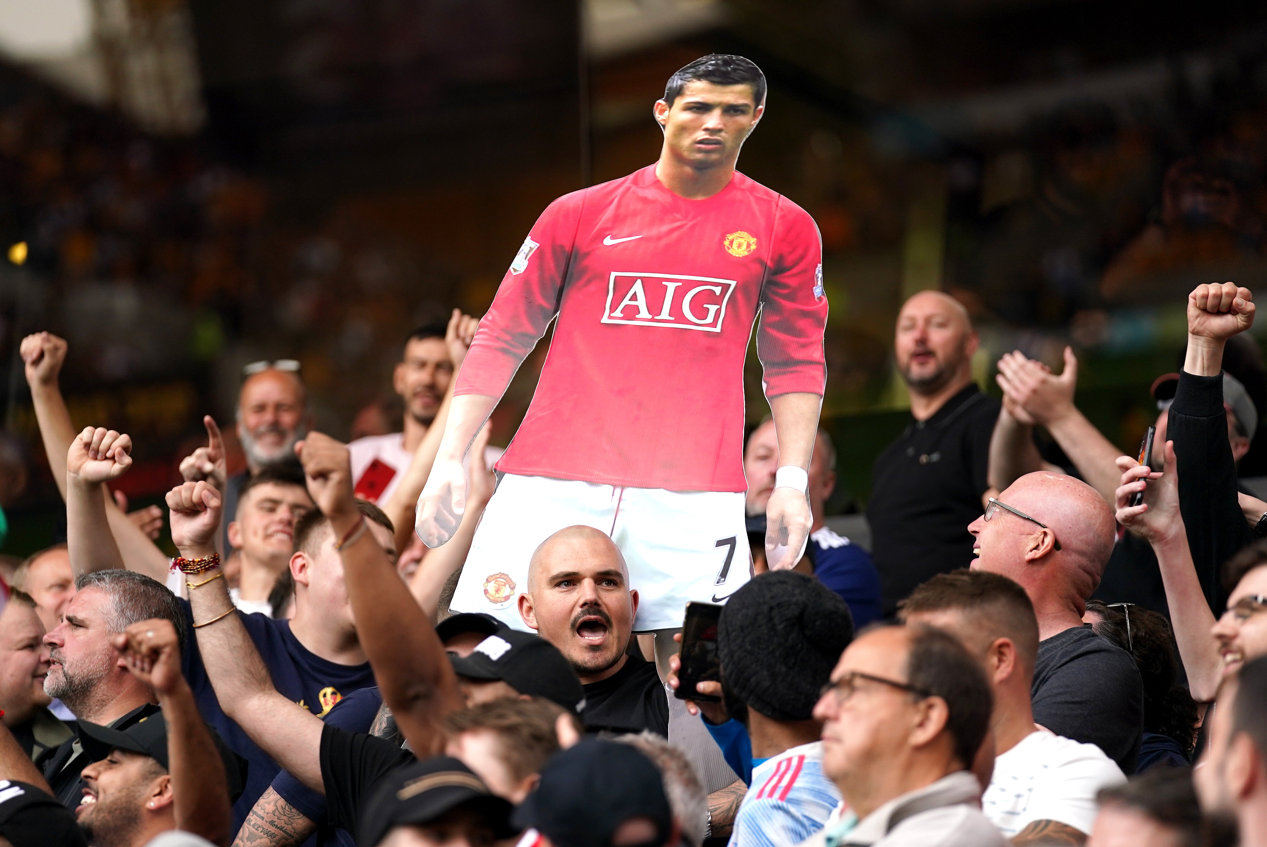 Manchester United fans celebrate Cristiano Ronaldo’s impending return to the club during Sunday’s 1-0 Premier League win at Wolves