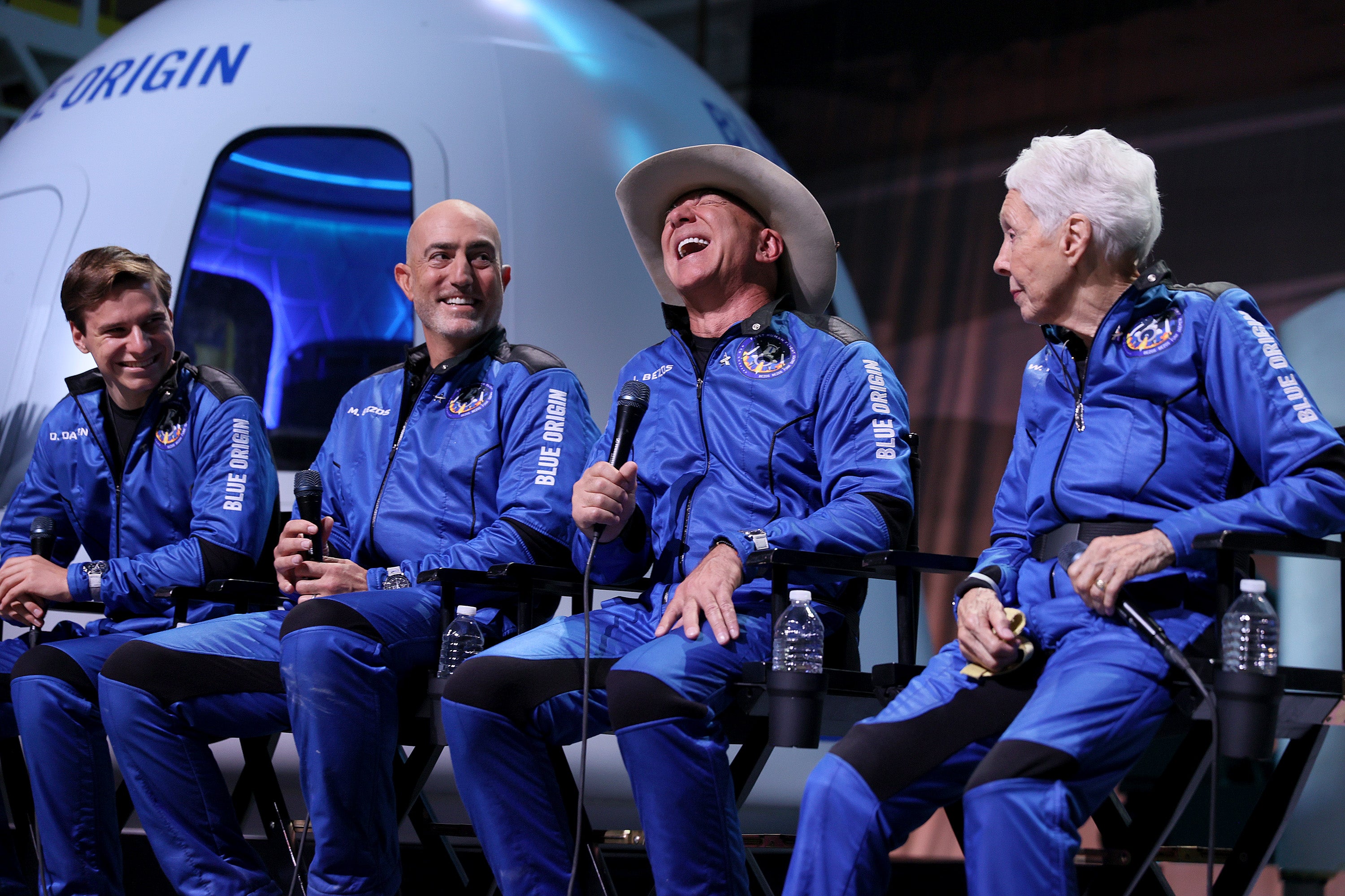 Blue Origin’s New Shepard crew (L-R) Oliver Daemen, Mark Bezos, Jeff Bezos, and Wally Funk hold a press conference after flying into space