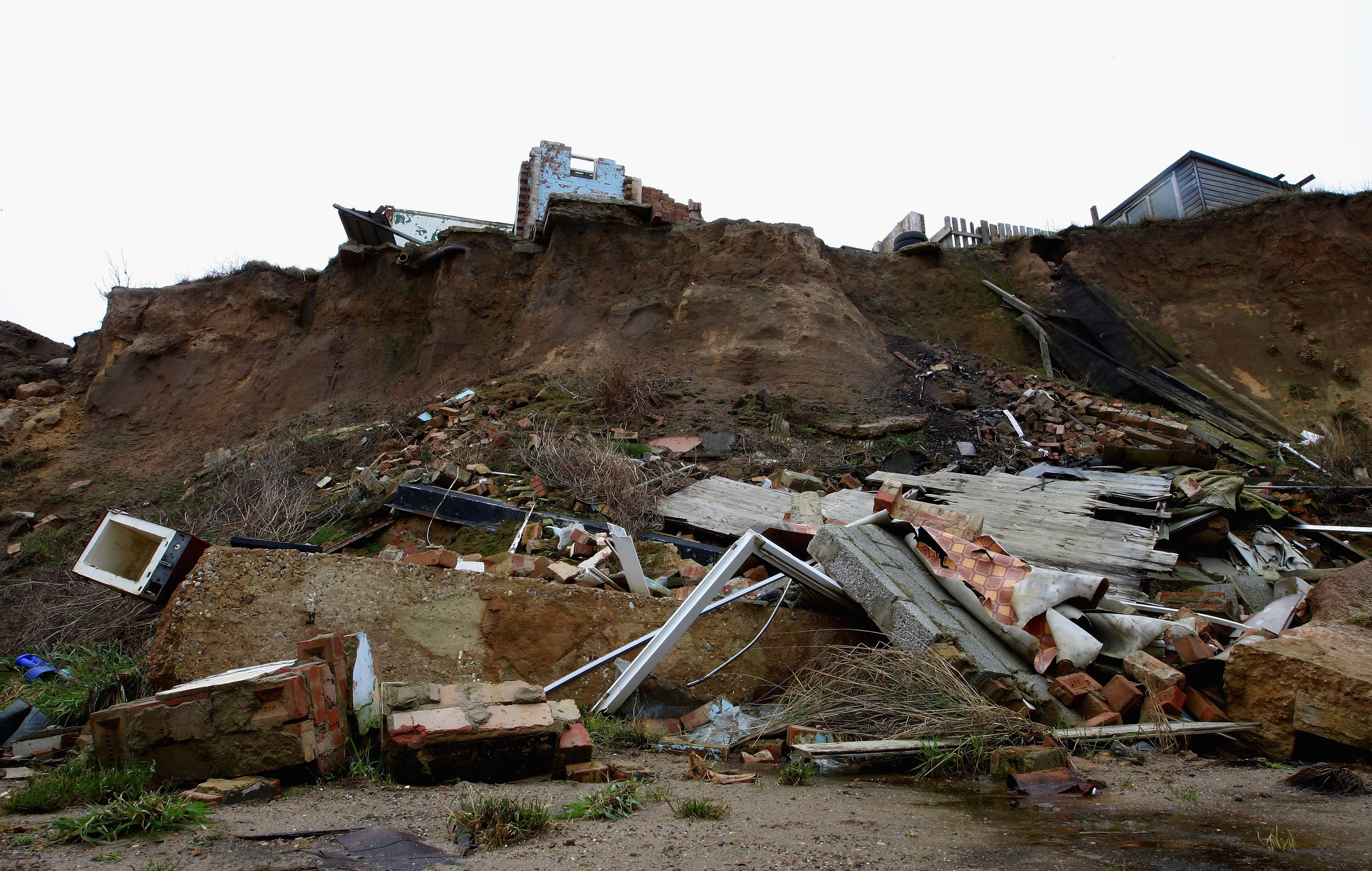 Rubble from buildings that have fallen off the cliff edge due to erosion