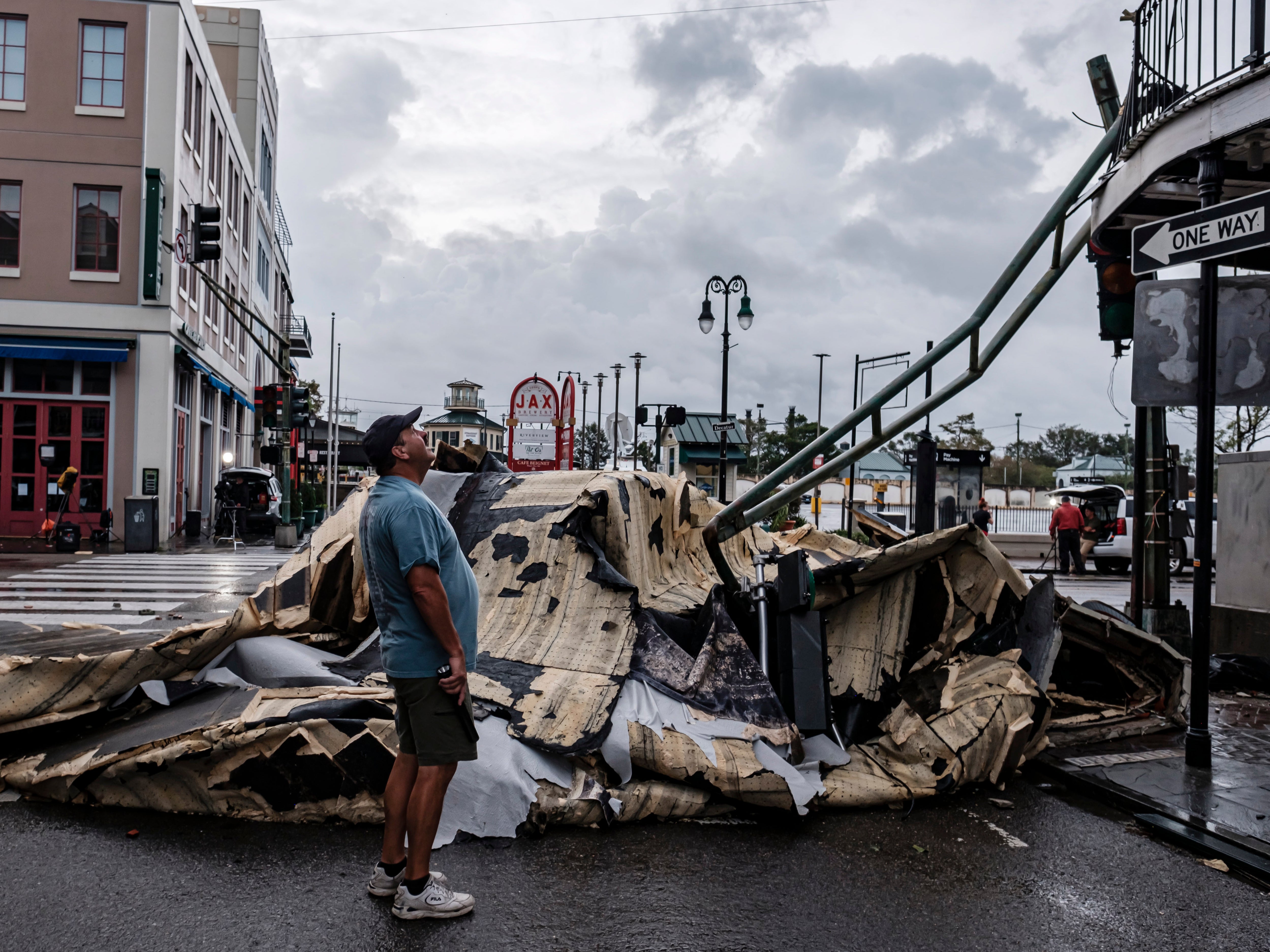 A man looks up next to a chunk of roof that ripped off a building the French Quarter due to Hurricane Ida in New Orleans, Louisiana