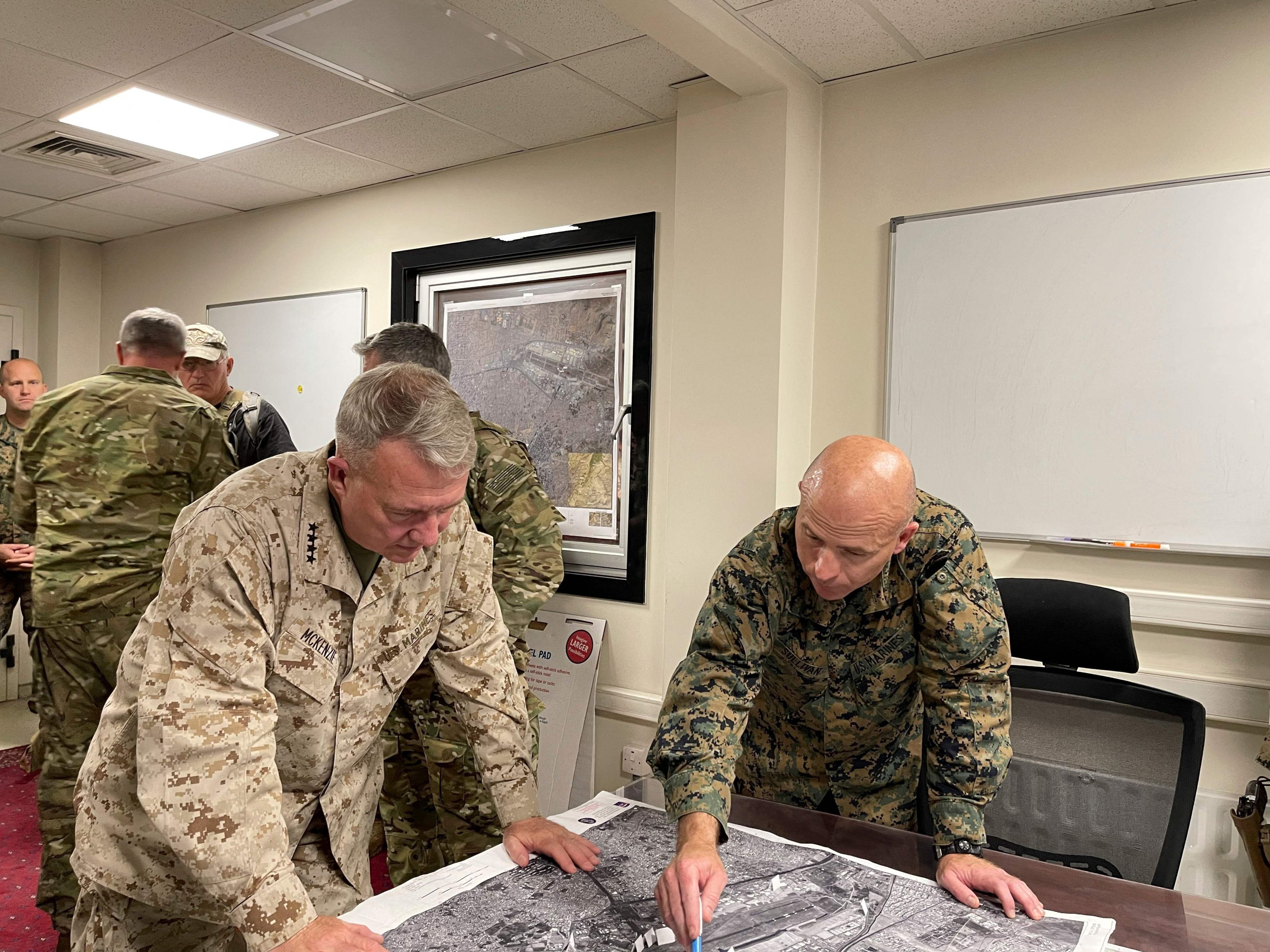 <p>This US Navy photo released on August 18, 2021 shows US Marine Corps Gen. Frank McKenzie(L), the commander of US Central Command, directing operations with US Marine Brig. Gen. Farrell J. Sullivan, the commander of the Naval Amphibious Task Force 51/5th Marine Expeditionary Brigade, at Hamid Karzai International Airport, Afghanistan on August 17, 2021. - The Taliban have offered a pledge of reconciliation, vowing no revenge against opponents and to respect women's rights in a "different" rule of Afghanistan from two decades ago. The announcements came on Tuesday night shortly after the return to Afghanistan of their co-founder, crowning the group's astonishing comeback after being ousted by a US-led invasion in 2001. (Photo by William URBAN / US NAVY / AFP) / RESTRICTED TO EDITORIAL USE - MANDATORY CREDIT "AFP PHOTO /US NAVY/WILLIAM URBAN/HANDOUT " - NO MARKETING - NO ADVERTISING CAMPAIGNS - DISTRIBUTED AS A SERVICE TO CLIENTS (Photo by WILLIAM URBAN/US NAVY/AFP via Getty Images)</p>