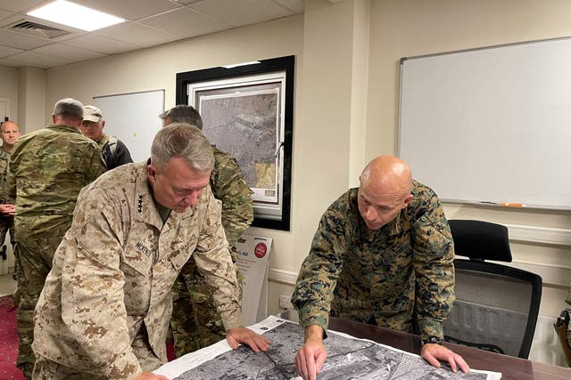 <p>This US Navy photo released on August 18, 2021 shows US Marine Corps Gen. Frank McKenzie(L), the commander of US Central Command, directing operations with US Marine Brig. Gen. Farrell J. Sullivan, the commander of the Naval Amphibious Task Force 51/5th Marine Expeditionary Brigade, at Hamid Karzai International Airport, Afghanistan on August 17, 2021. - The Taliban have offered a pledge of reconciliation, vowing no revenge against opponents and to respect women's rights in a "different" rule of Afghanistan from two decades ago. The announcements came on Tuesday night shortly after the return to Afghanistan of their co-founder, crowning the group's astonishing comeback after being ousted by a US-led invasion in 2001. (Photo by William URBAN / US NAVY / AFP) / RESTRICTED TO EDITORIAL USE - MANDATORY CREDIT "AFP PHOTO /US NAVY/WILLIAM URBAN/HANDOUT " - NO MARKETING - NO ADVERTISING CAMPAIGNS - DISTRIBUTED AS A SERVICE TO CLIENTS (Photo by WILLIAM URBAN/US NAVY/AFP via Getty Images)</p>