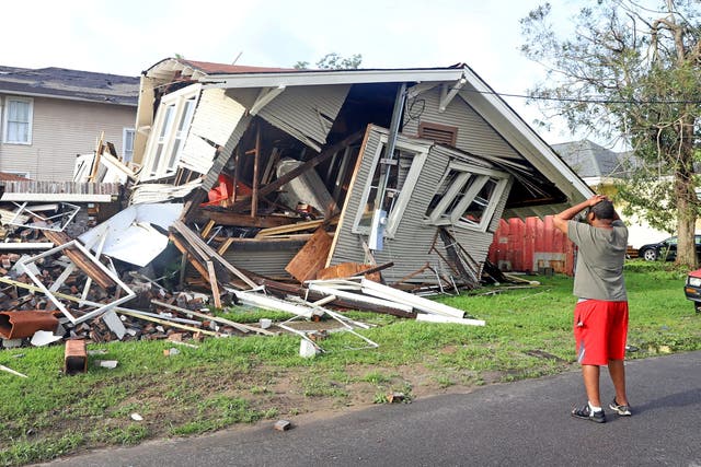 <p>Dartanian Stovall looks at the house that collapsed with him inside during the height of Hurricane Ida in New Orleans, Louisiana in August 30</p>