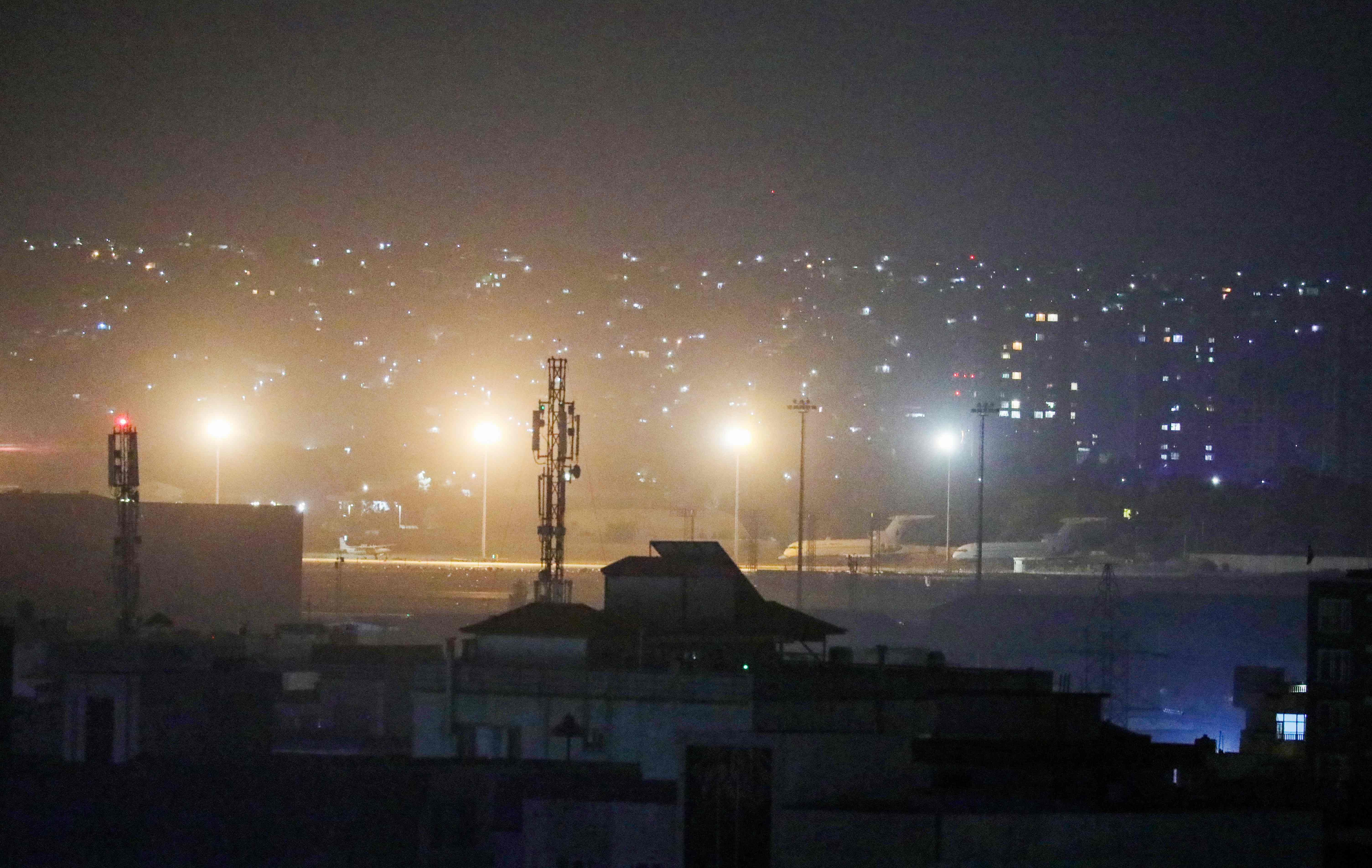 Planes are seen on the tarmac at the airport in Kabul late on August 30, 2021, hours ahead of a US deadline to complete its frenzied withdrawal from Afghanistan