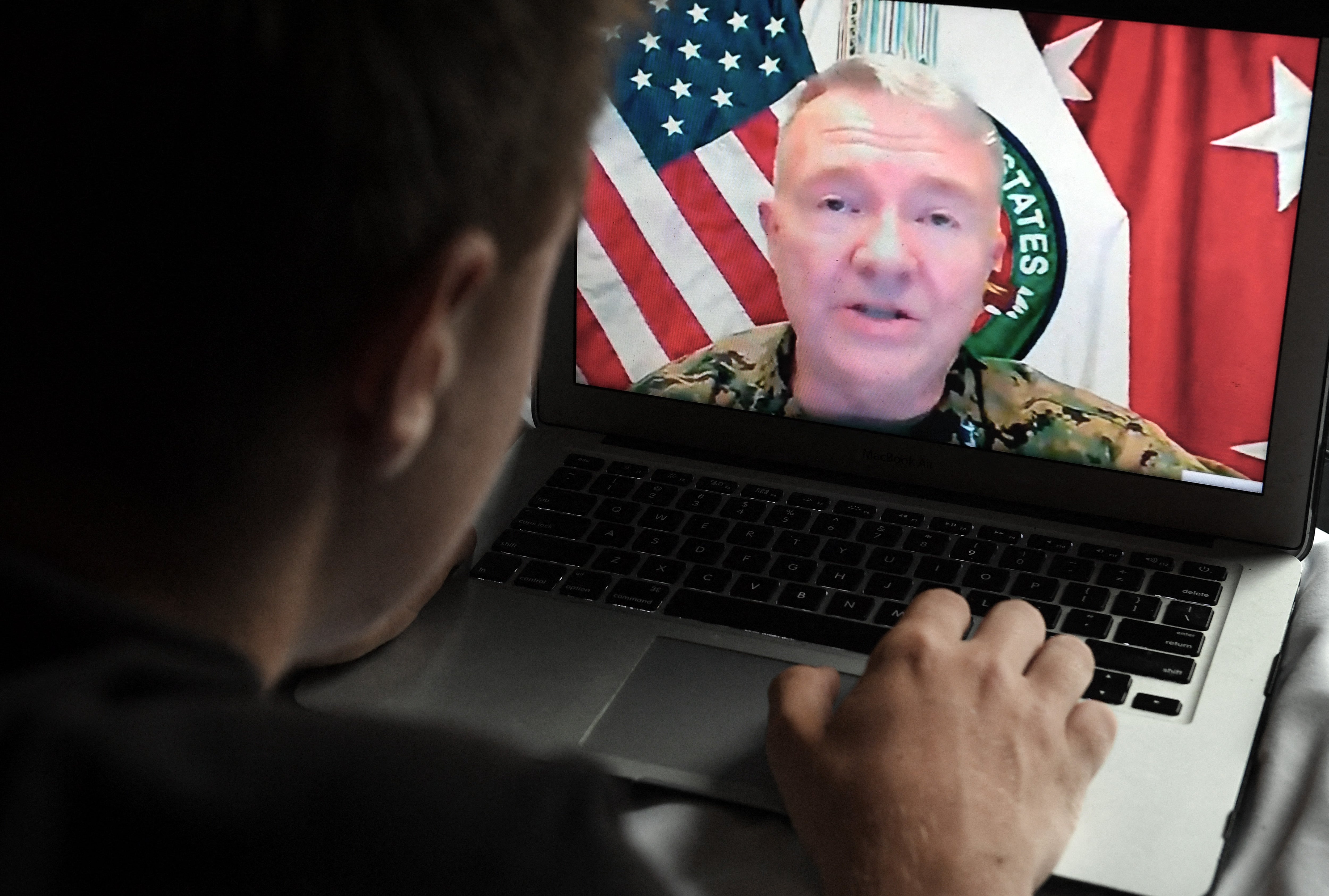 <p>A person watching the press briefing of General Kenneth McKenzie on 30 August when he announced the departure of the last US troops from Afghanistan, concluding a 20-year conflict that ended with the Taliban seizing control of the country</p>
