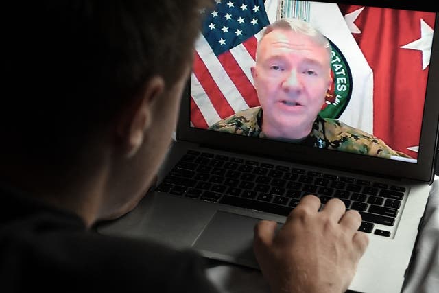 <p>A person watching the press briefing of General Kenneth McKenzie on 30 August when he announced the departure of the last US troops from Afghanistan, concluding a 20-year conflict that ended with the Taliban seizing control of the country</p>