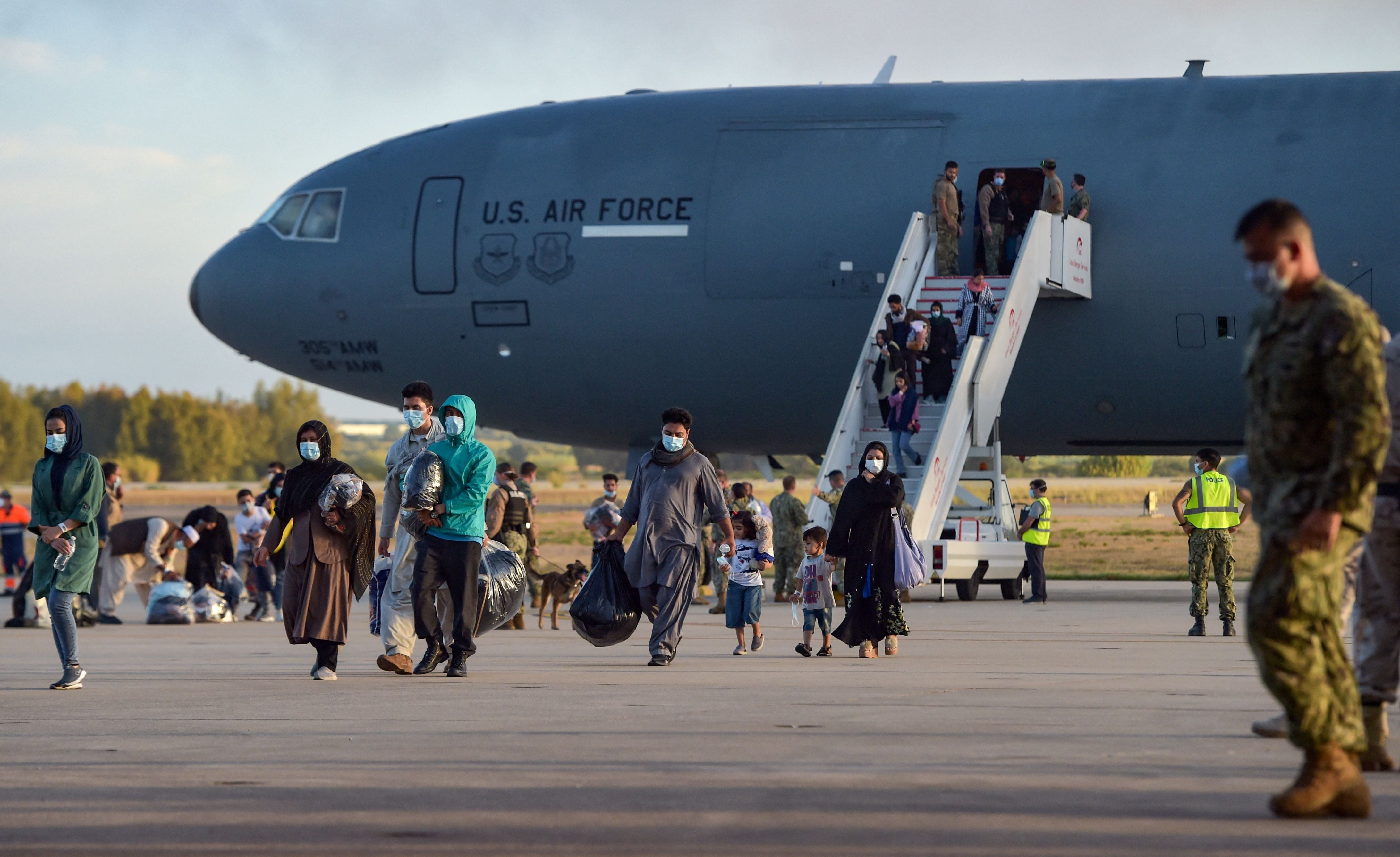 Refugees disembark from a US air force aircraft after an evacuation flight from Kabul at the Rota naval base in Rota, southern Spain, on 31 August 2021. - Japan was heavily criticised for evacuating just one passenger on its C-130 aircraft.