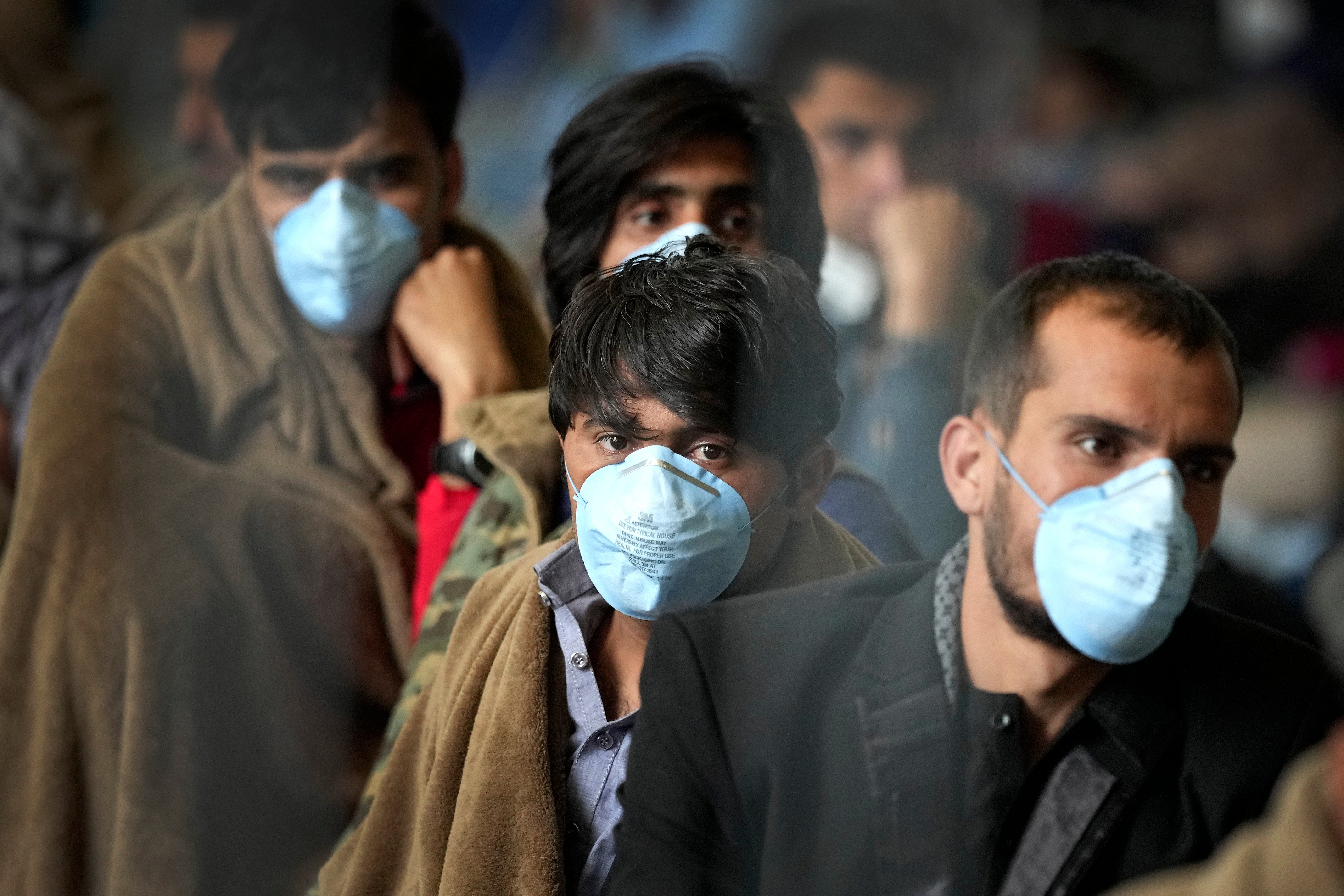 People wait for their departure at a hangar of the Ramstein U.S. Air Base in Ramstein, Germany.