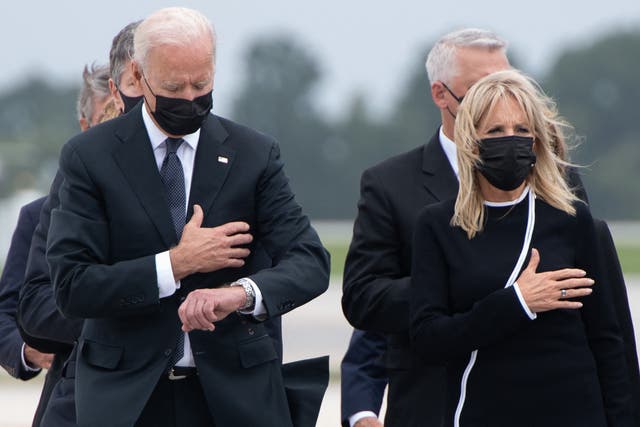 <p>US President Joe Biden looks down alongside First Lady Jill Biden as they attend the dignified transfer of the remains of a fallen service member at Dover Air Force Base in Dover, Delaware, August, 29, 2021</p>