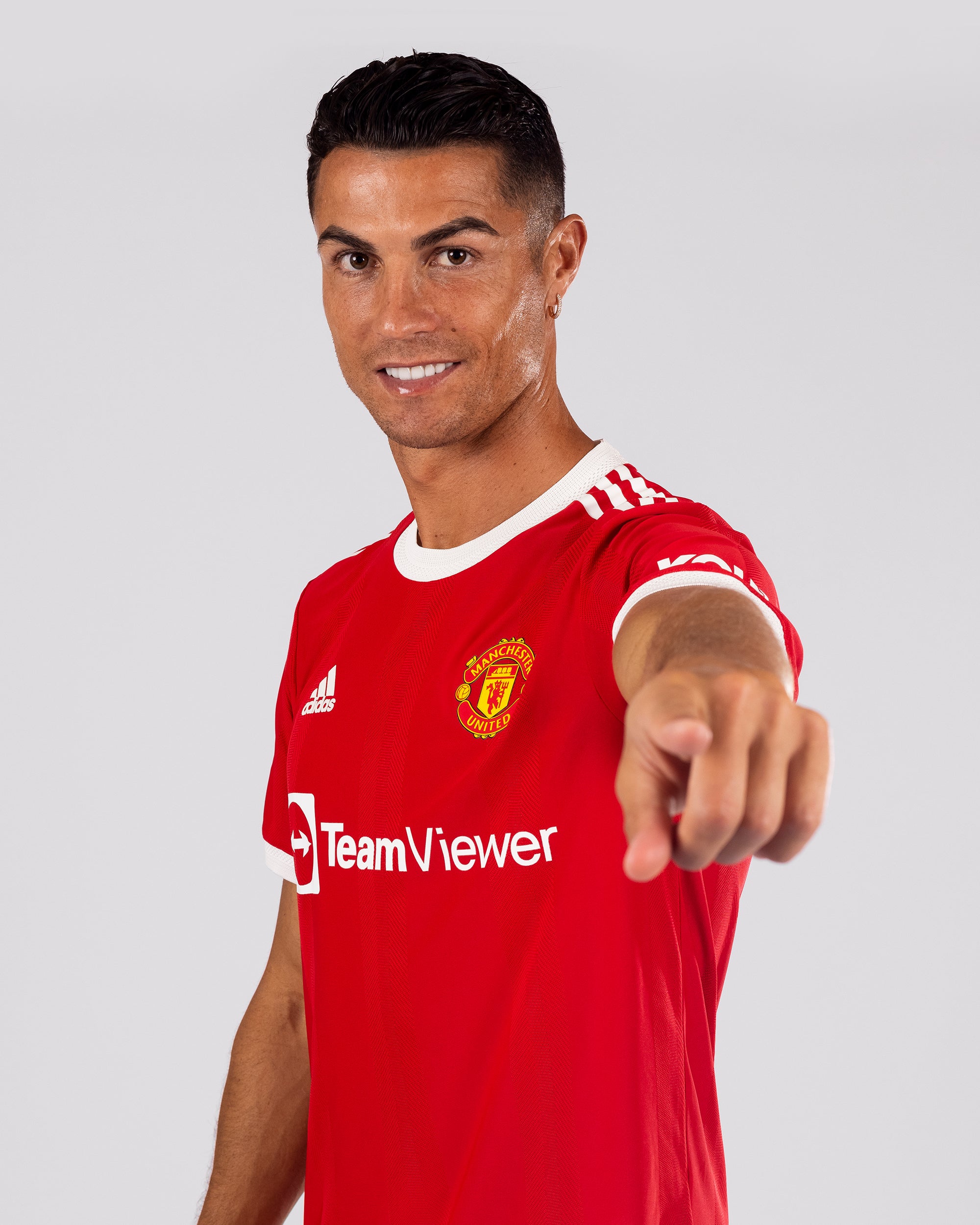 Cristiano Ronaldo of Manchester United poses after signing for the club