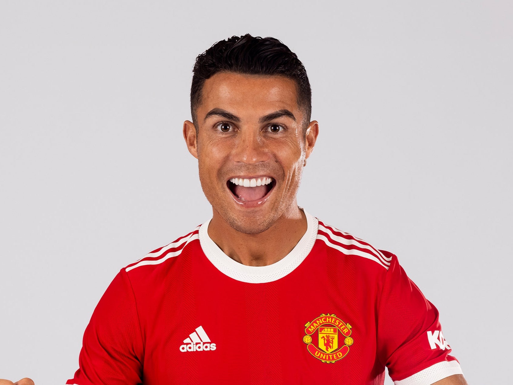 Cristiano Ronaldo of Manchester United poses after signing for the club