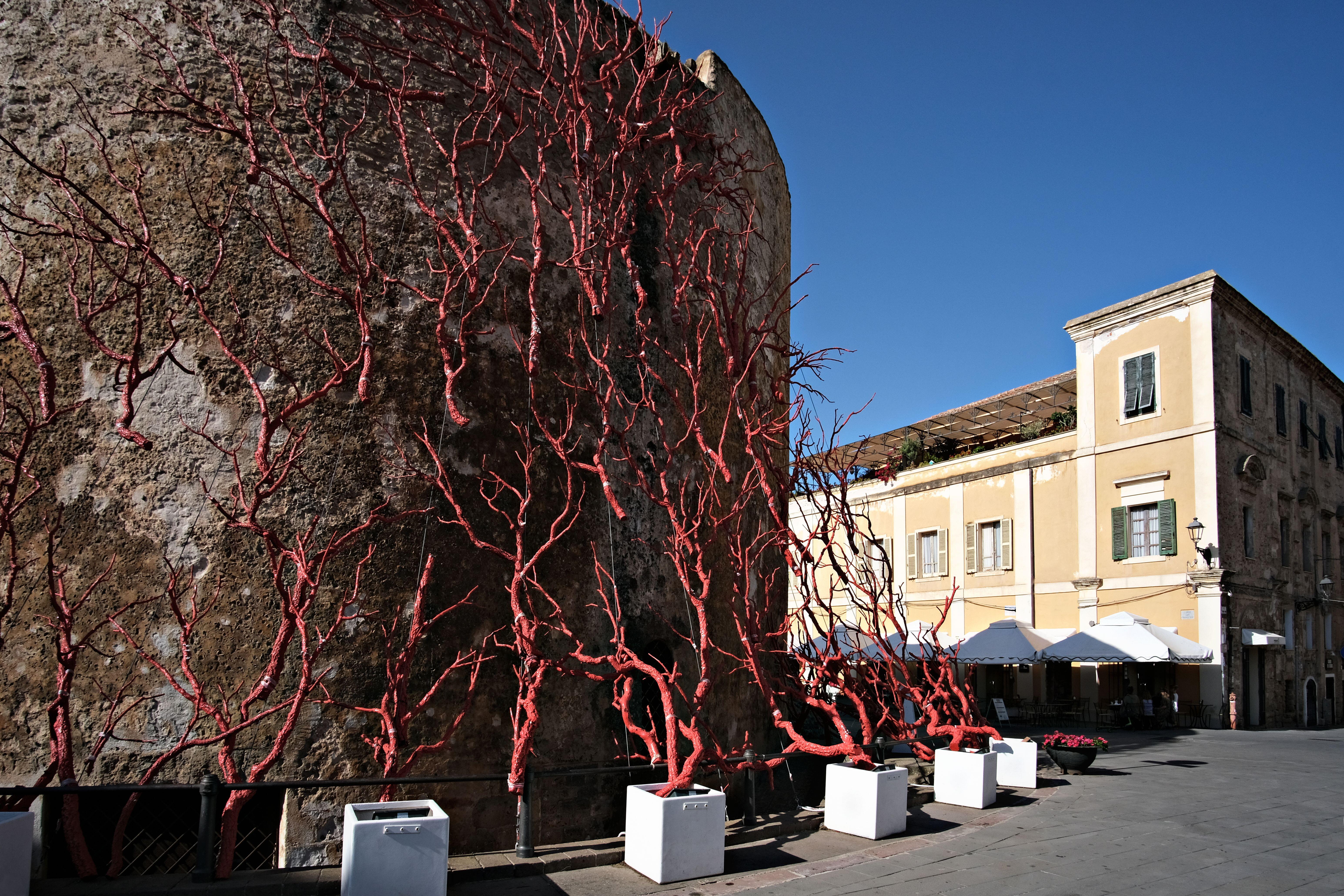Tower in Alghero decorated with red coral (Alamy/PA)