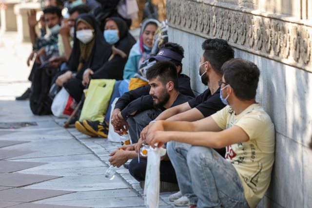 <p>Afghan nationals gather in front of the German embassy in Tehran </p>