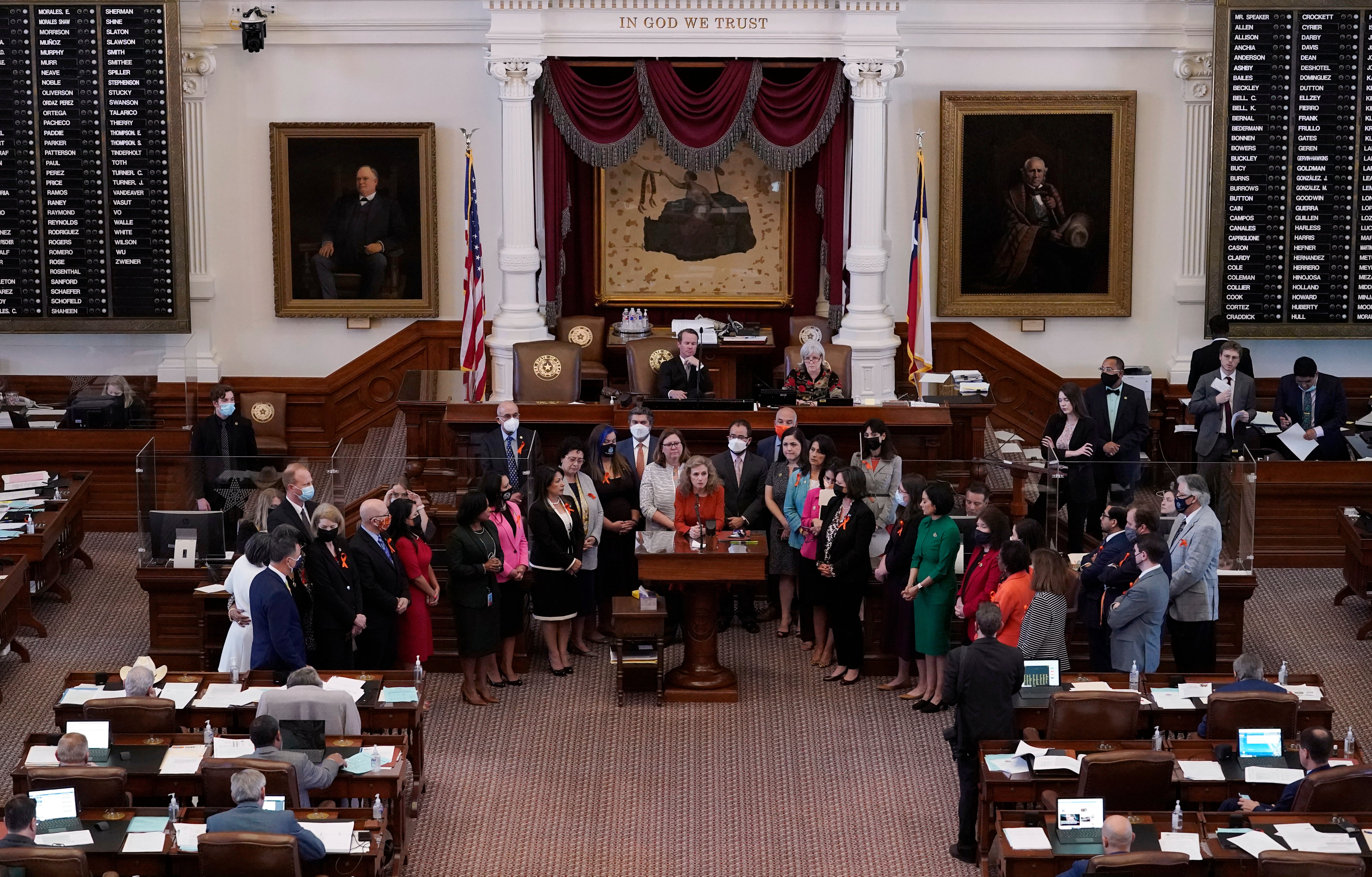 In this May 5, 2021, file photo, Texas state Rep. Donna Howard, D-Austin, center at lectern, stands with fellow lawmakers in the House Chamber in Austin, Texas, as she opposes a bill introduced that would ban abortions as early as six weeks and allow private citizens to enforce it through civil lawsuits, under a measure given preliminary approval by the Republican-dominated House