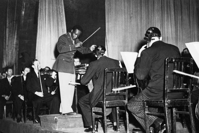 <p>Rudolph Dunbar leads the Berlin Philharmonic orchestra in 1945</p>