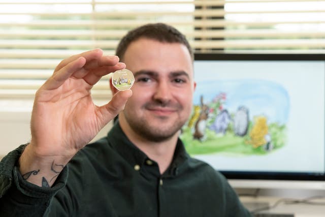 Royal Mint designer Daniel Thorne with the new Winnie-the-Pooh and Friends 50p coin (Royal Mint/PA)