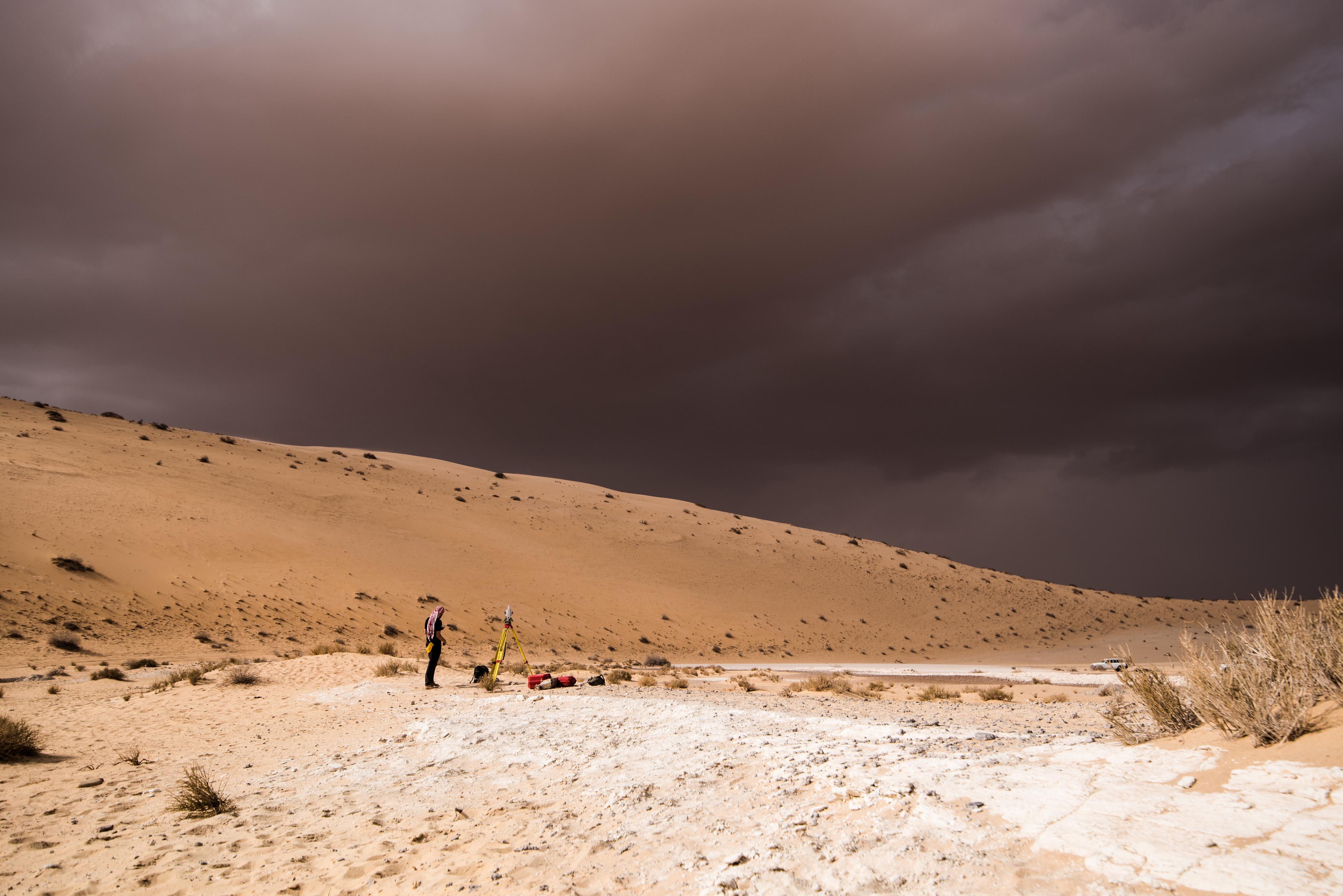 File: A storm arrives during an archaeological excavation of the remains of an ancient lake in northern Saudi Arabia, where ancient humans lived alongside animals like hippos