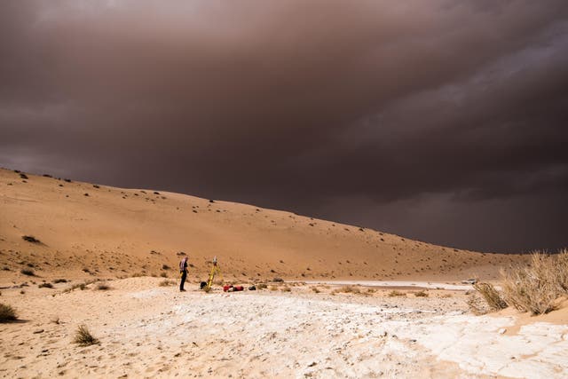 <p>File: A storm arrives during an archaeological excavation of the remains of an ancient lake in northern Saudi Arabia, where ancient humans lived alongside animals like hippos</p>