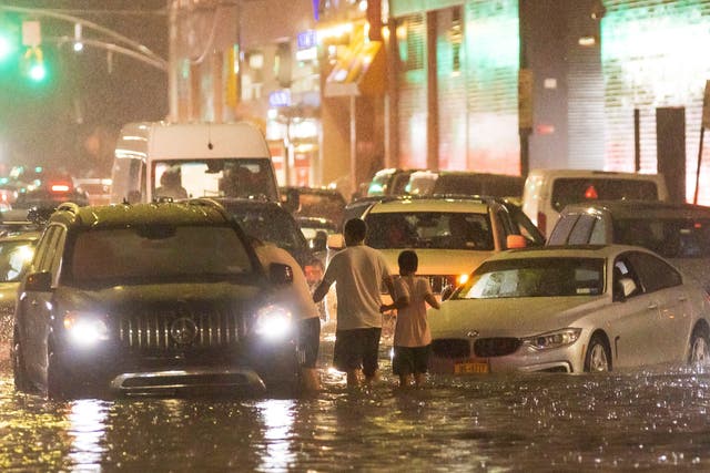 <p>Cars stuck on a street flooded by heavy rain in the Queens borough of New York</p>