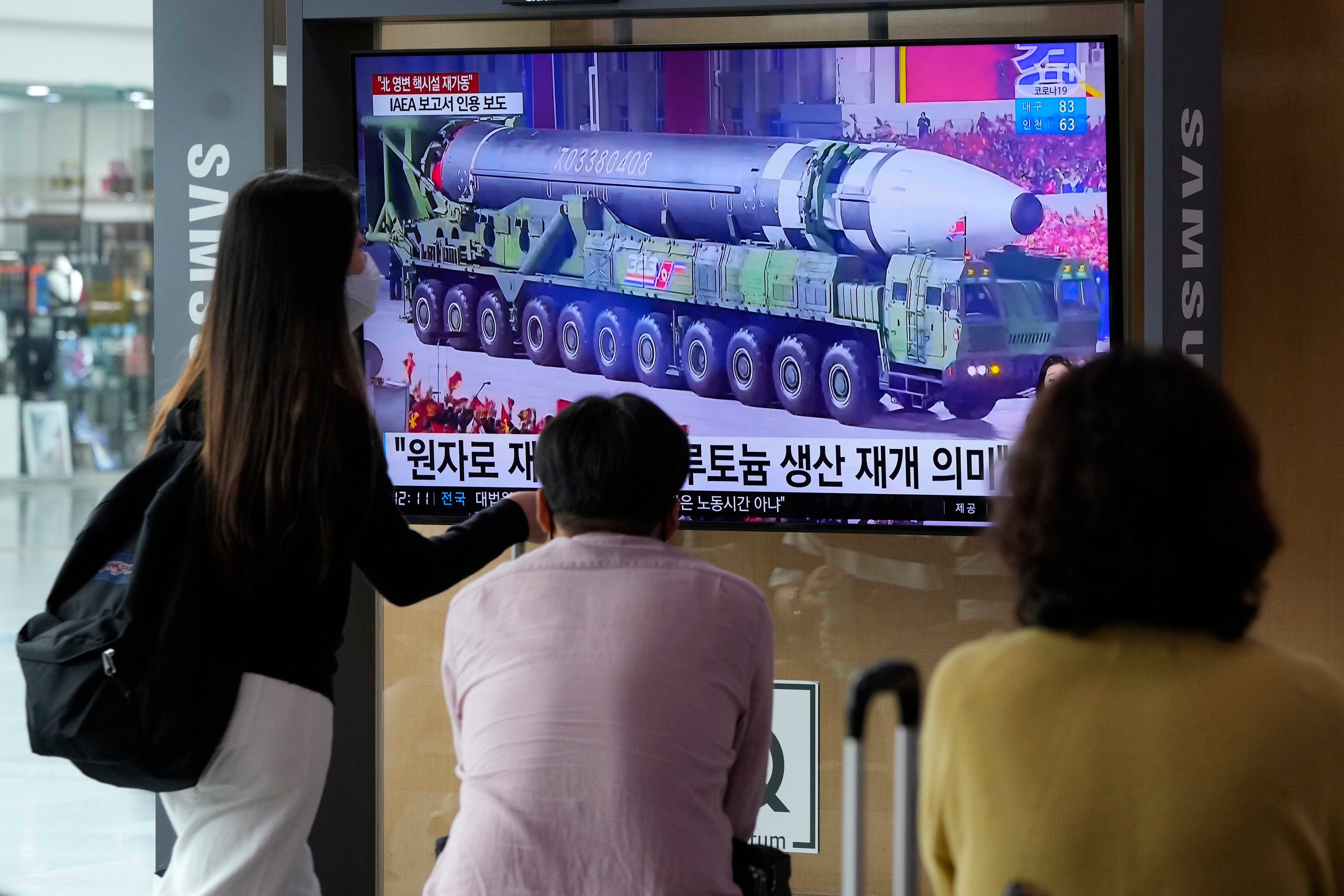 People watch a TV screen showing a file image of a North Korean missile in a military parade during a news program at the Seoul Railway Station in Seoul, South Korea, Monday