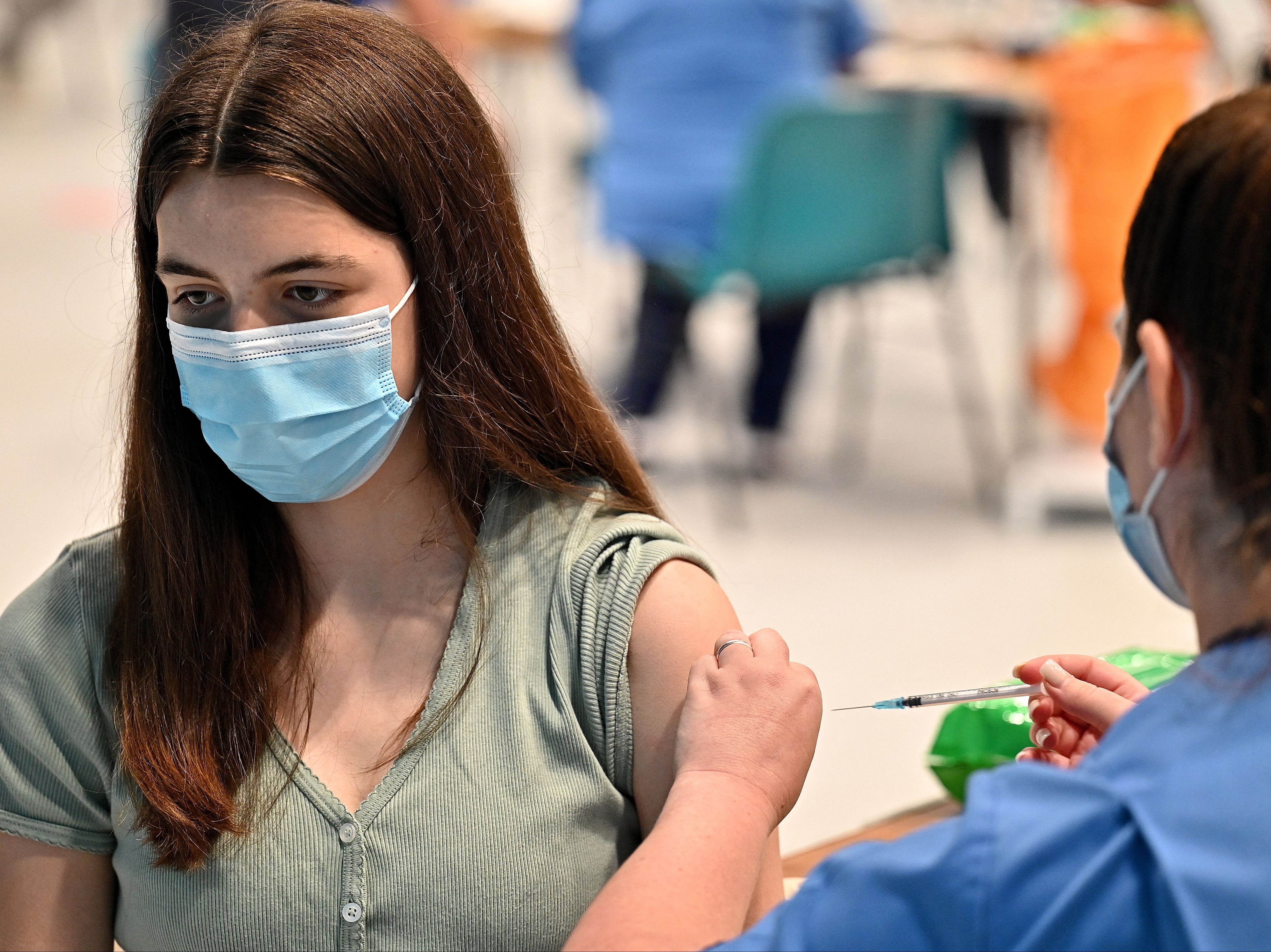 Teenager Katie Moore receives a Covid-19 jab at a vaccination centre in Barrhead, south of Glasgow