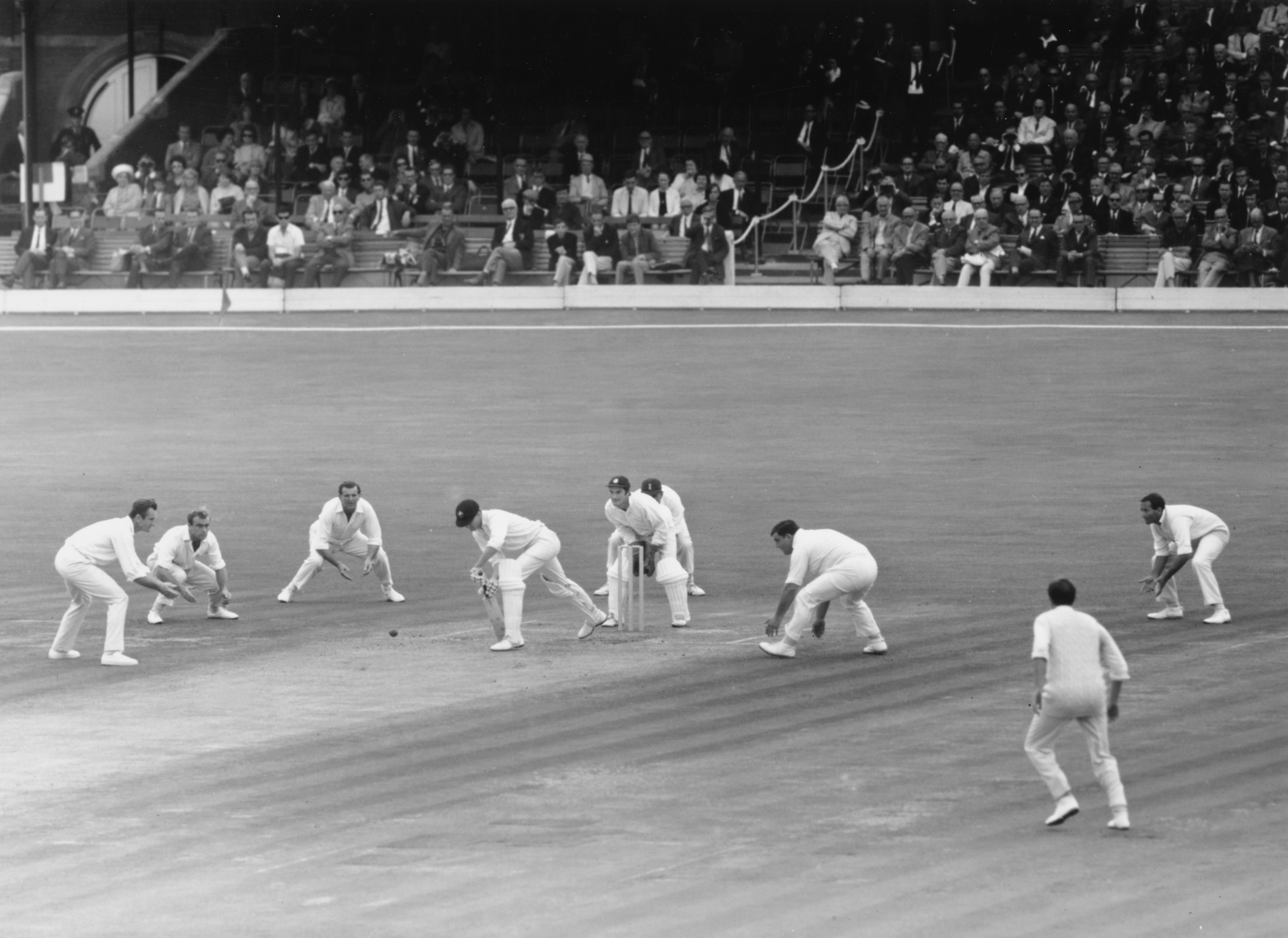 From left: Ted Dexter, John Edrich, Tom Graveney, Alan Knott, Colin Cowdrey, Colin Milburn and Basil D'Oliveira of England surround Australia’s Ashley Mallett as he plays a forward defensive at the Oval in 1968