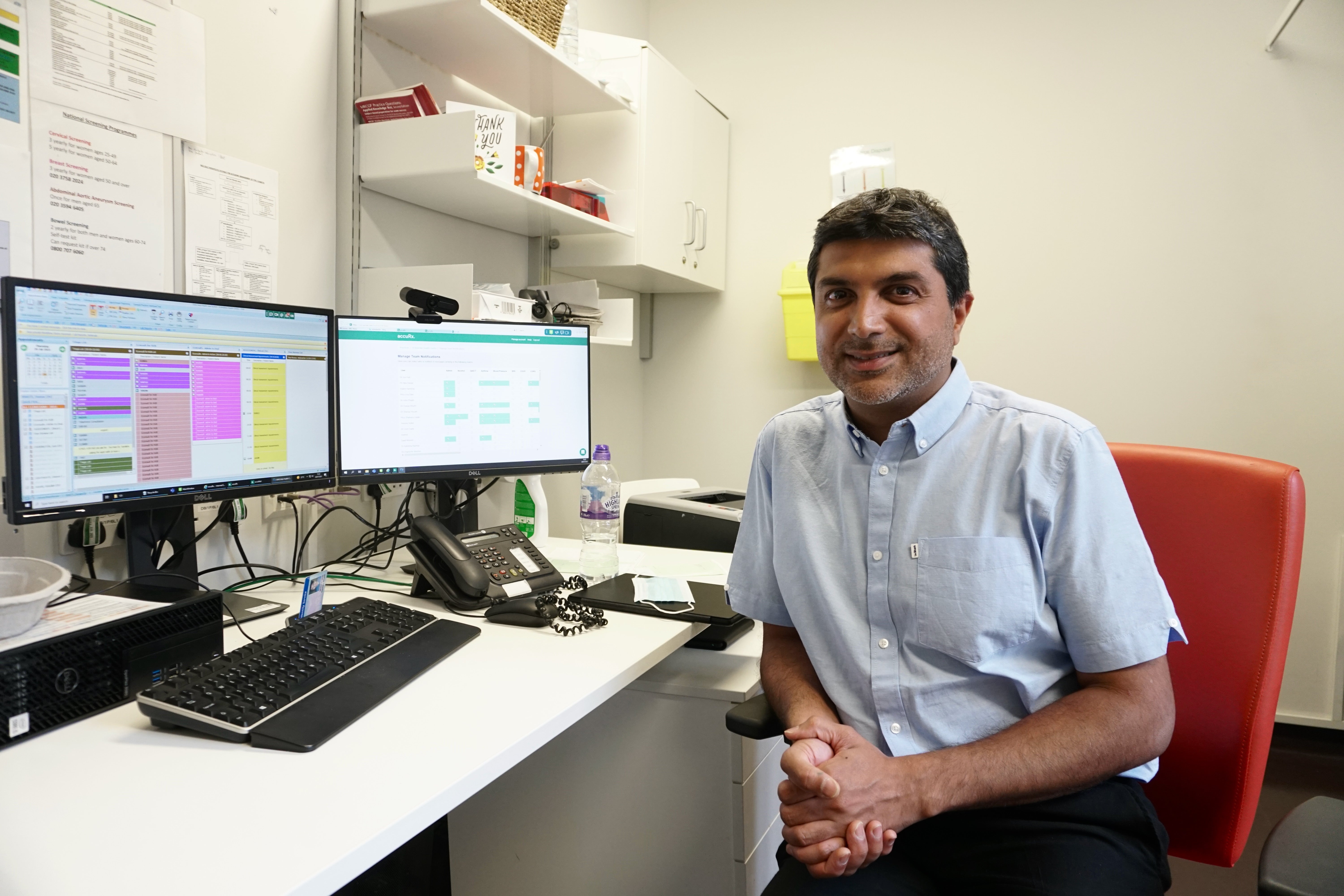 GP data sharing - Dr Osman Bhatti in his office at St Andrews Health Centre, Bromley-By-Bow, Tower Hamlets