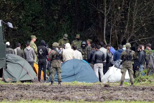 <p>Polish security forces surround migrants stuck along with border with Belarus in Usnarz Gorny, Poland</p>