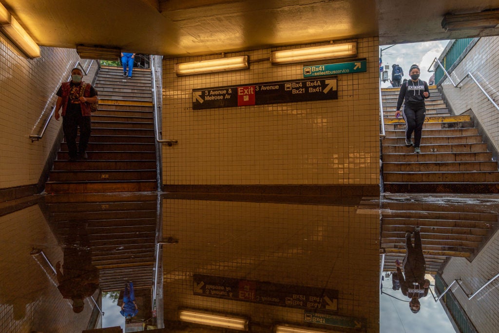 Commuters walk into a flooded 3rd Avenue / 149th street subway station and disrupted service due to extremely heavy rainfall from the remnants of Hurricane Ida on 2 September