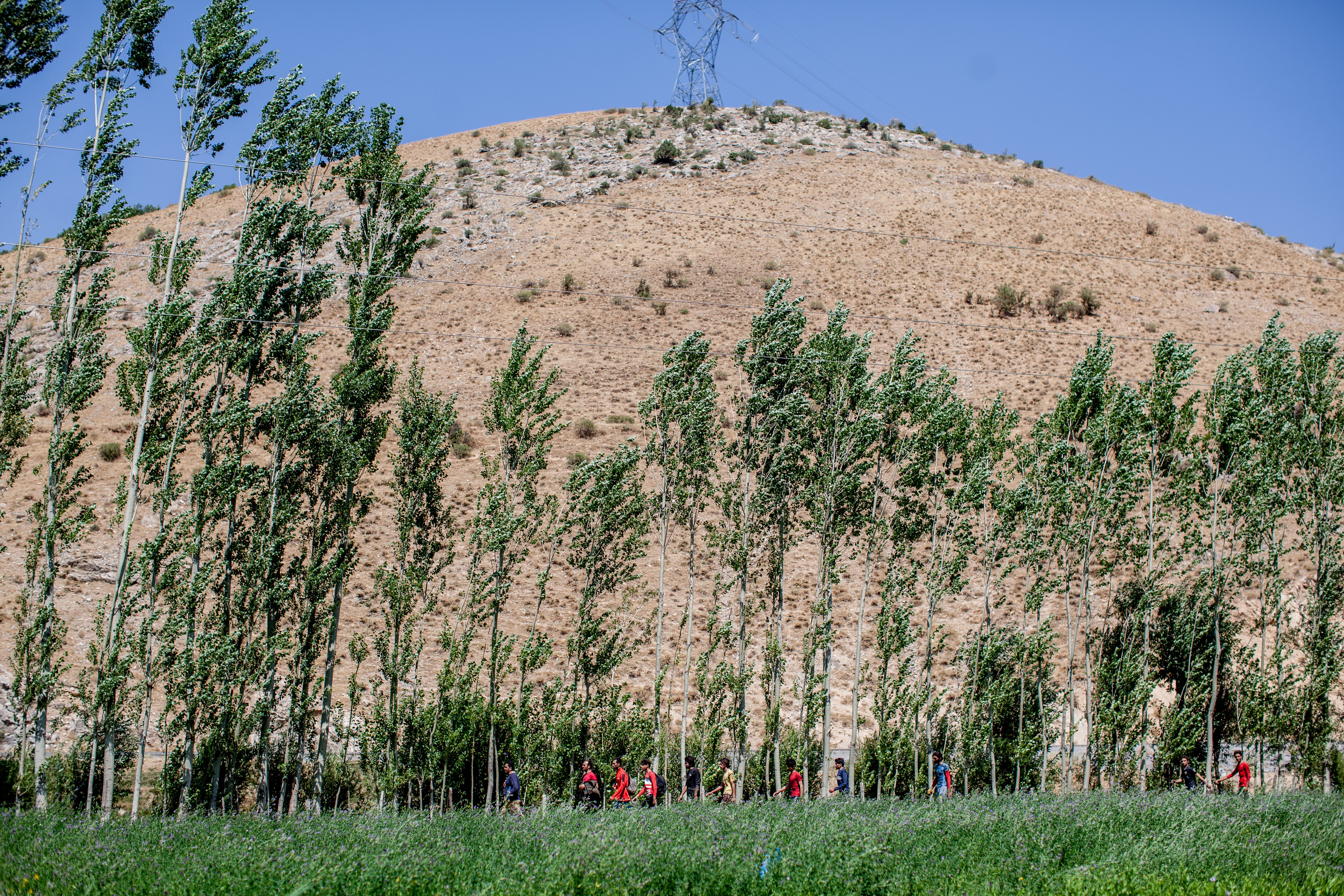 A group of Afghan refugees are seen trekking from the Iranian border to the town of Tatvan, a distance of over 200km. The refugees need to walk to avoid detection by security forces