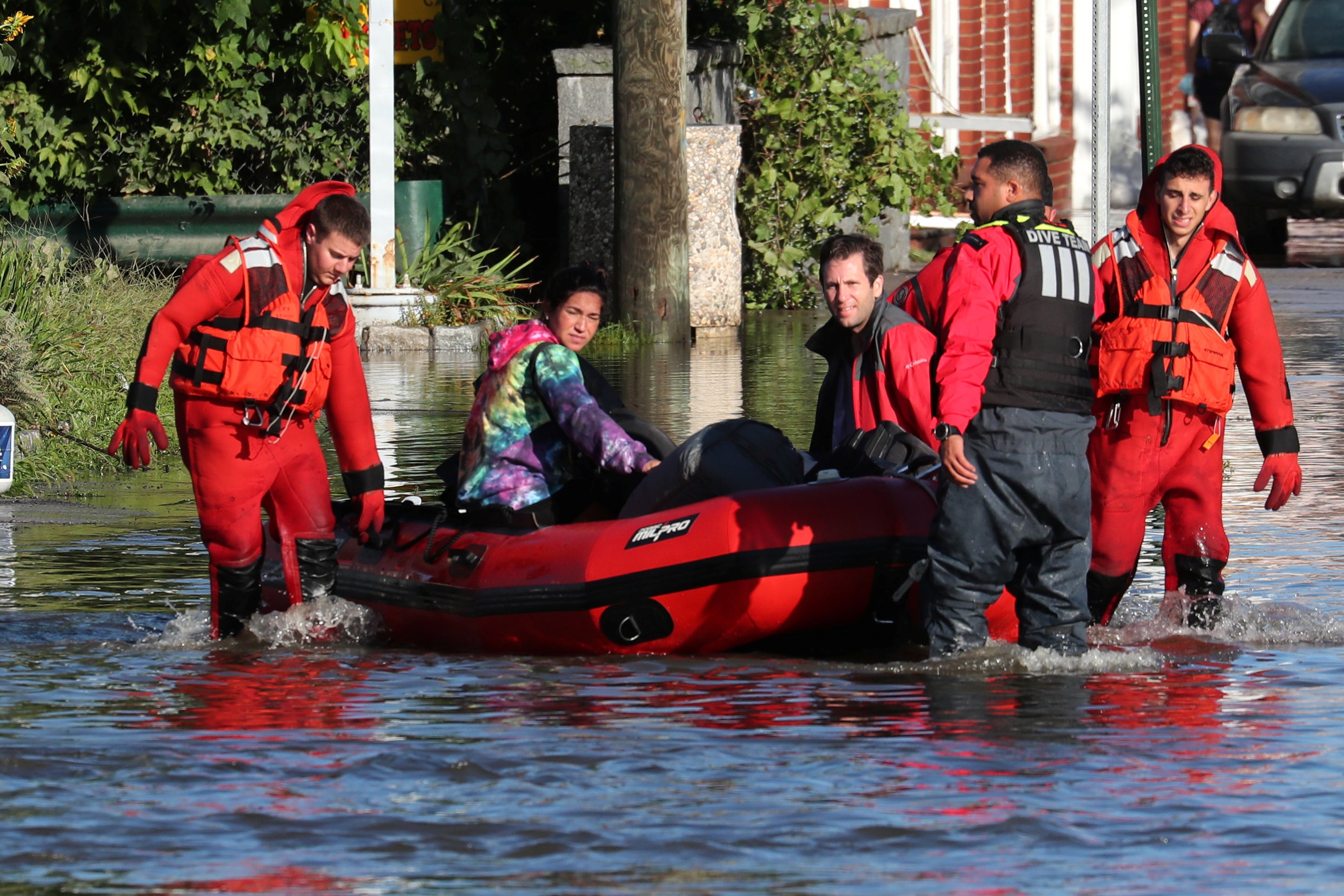 First responders pull local residents in a boat as they perform rescues of people trapped by floodwaters after the remnants of Tropical Storm Ida brought drenching rain, flash floods and tornadoes to parts of the northeast in Mamaroneck, New York