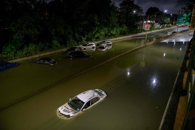 <p>Floodwater surrounds vehicles following heavy rain on an expressway in Brooklyn, New York early on September 2, 2021, as flash flooding and record-breaking rainfall brought by the remnants of Storm Ida swept through the area. </p>