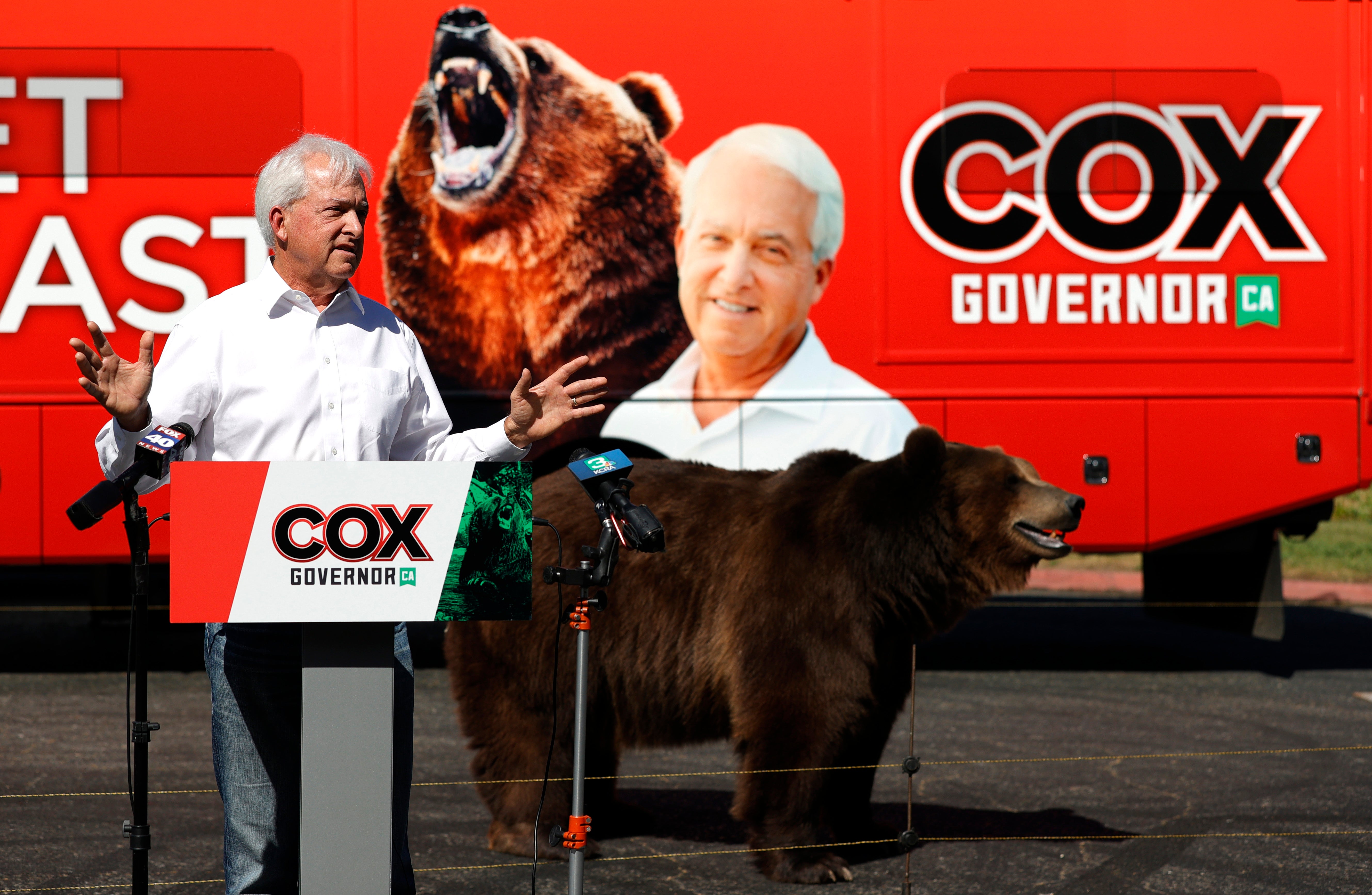 A 1,000 pound bear walks behind California republican gubernatorial candidate John Cox as he speaks during a campaign rally at Miller Regional Park on May 04, 2021 in Sacramento, California.