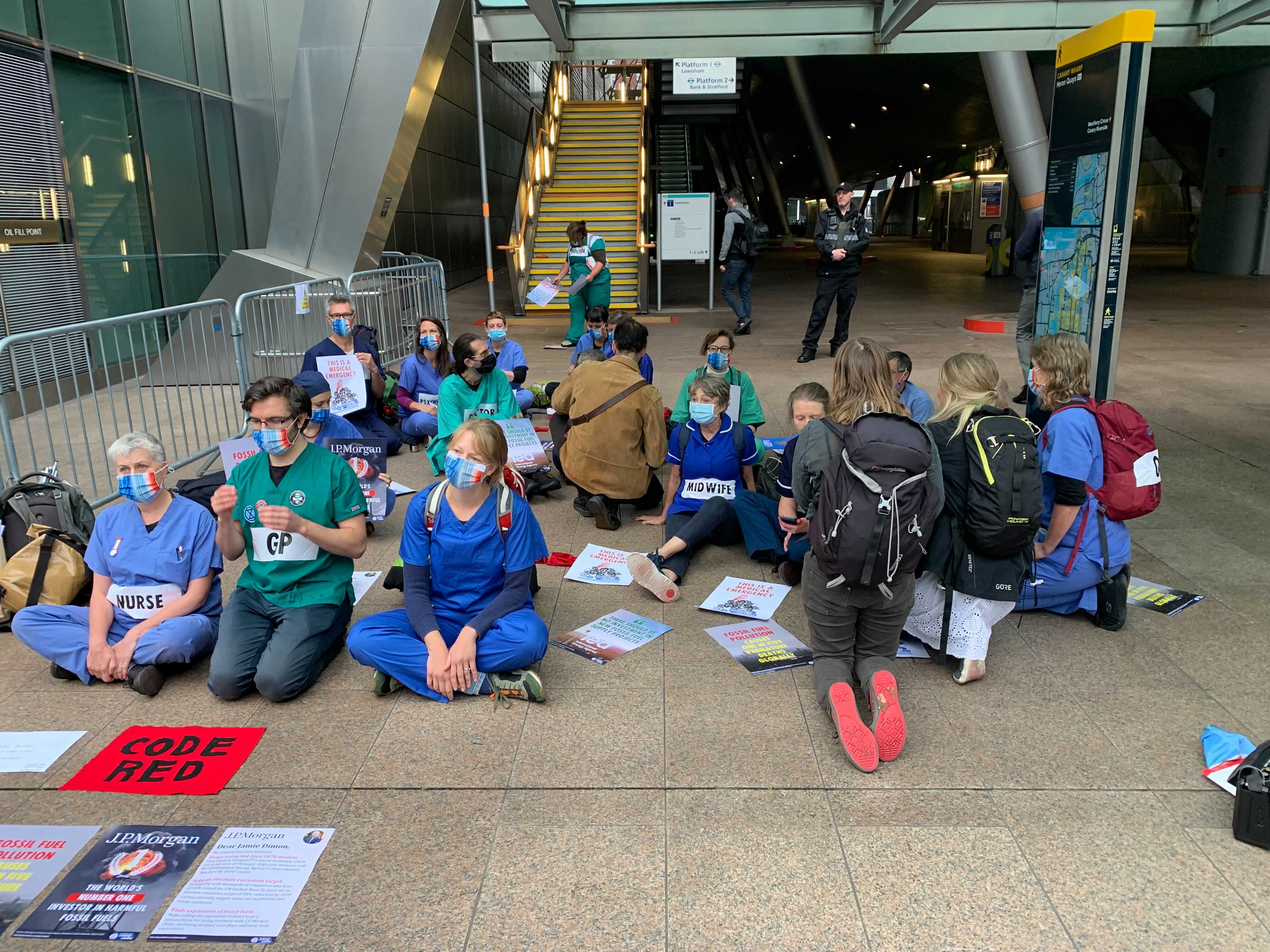 Protesters gathered outside a DLR station close to the bank’s HQ