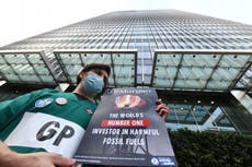 ‘It’s my duty as a doctor’: Extinction Rebellion medics glued to bank demand end of fossil fuel investment 