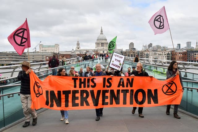 <p>Climate activists from the Extinction Rebellion group cross the Millennium bridge in London on 2 September</p>