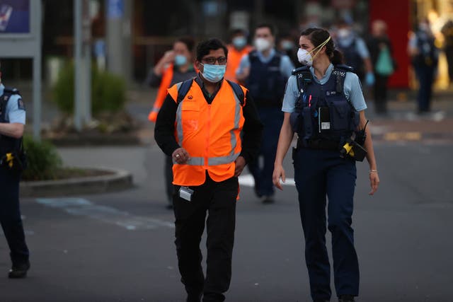 <p>Police help people from LynnMall to their cars after the terrorist attack in Auckland</p>